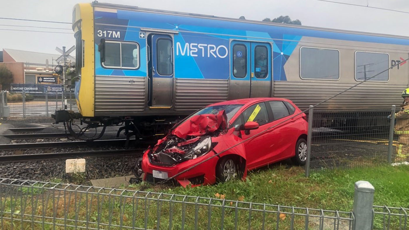 Car stuck by train at level crossing Melbourne news