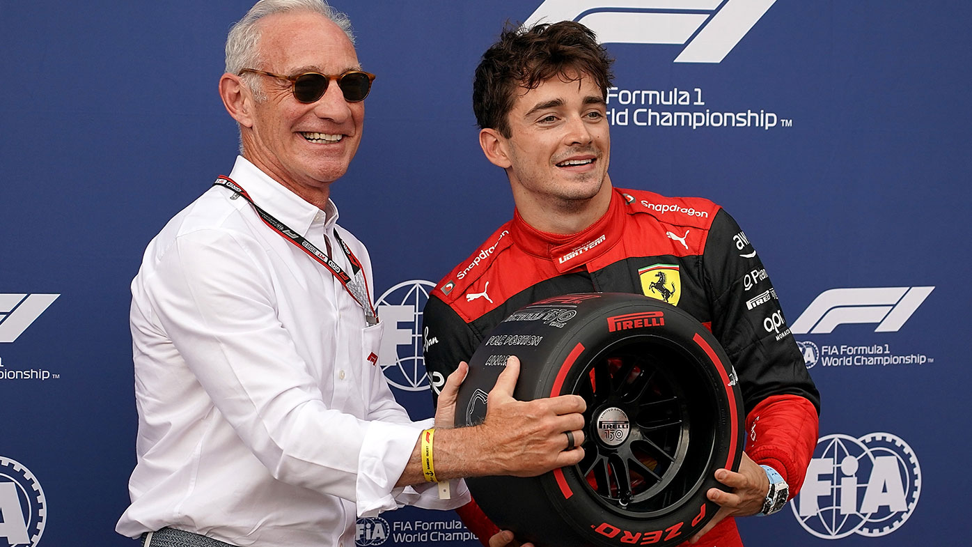 : Monacan driver Charles Leclerc (R) of Ferrari receives pole position trophy from Liberty CEO Greg Maffei (L) after qualifying 