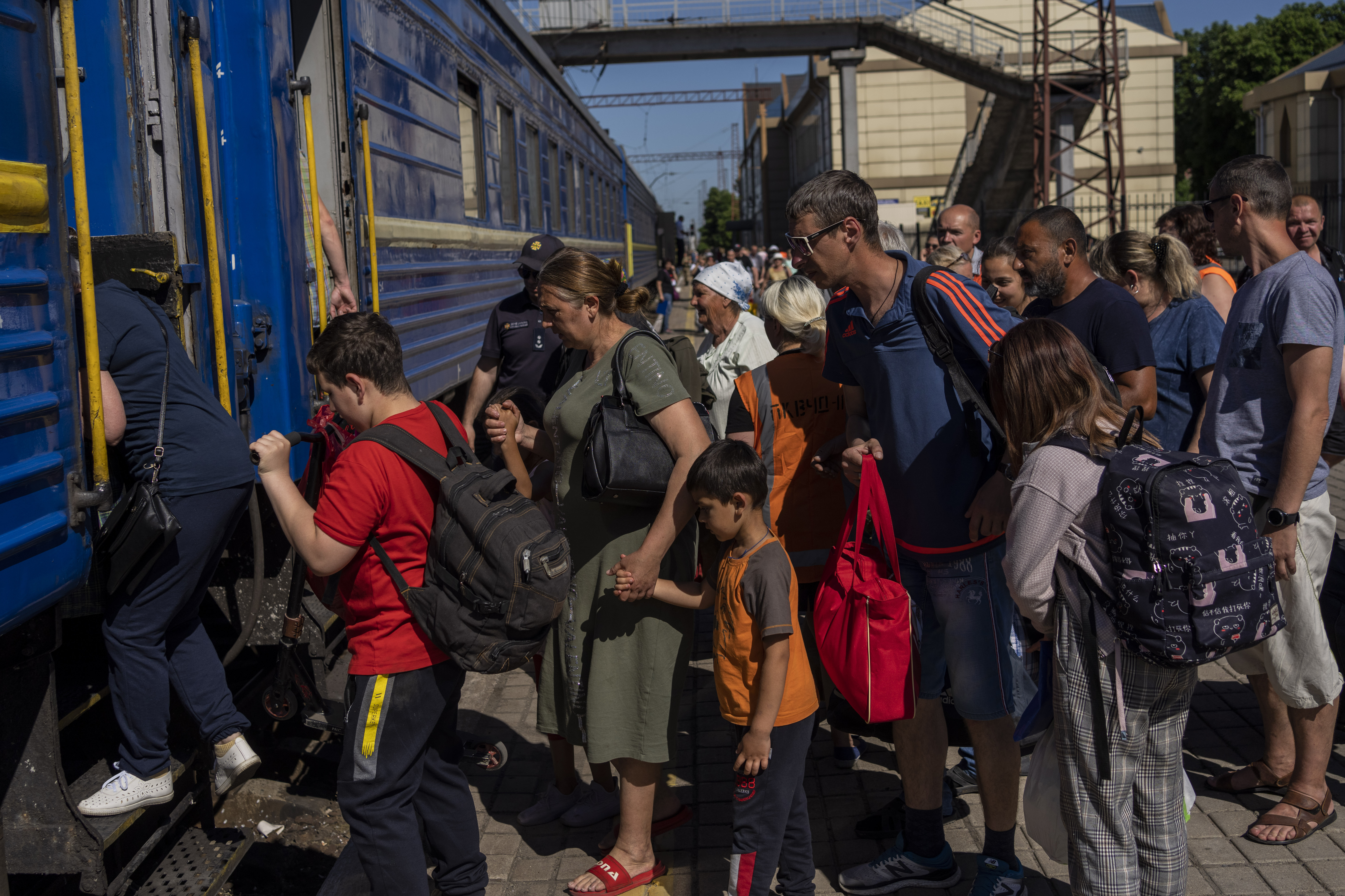 People board an evacuation train in Pokrovsk railway station, eastern Ukraine, Friday, June 10, 2022.