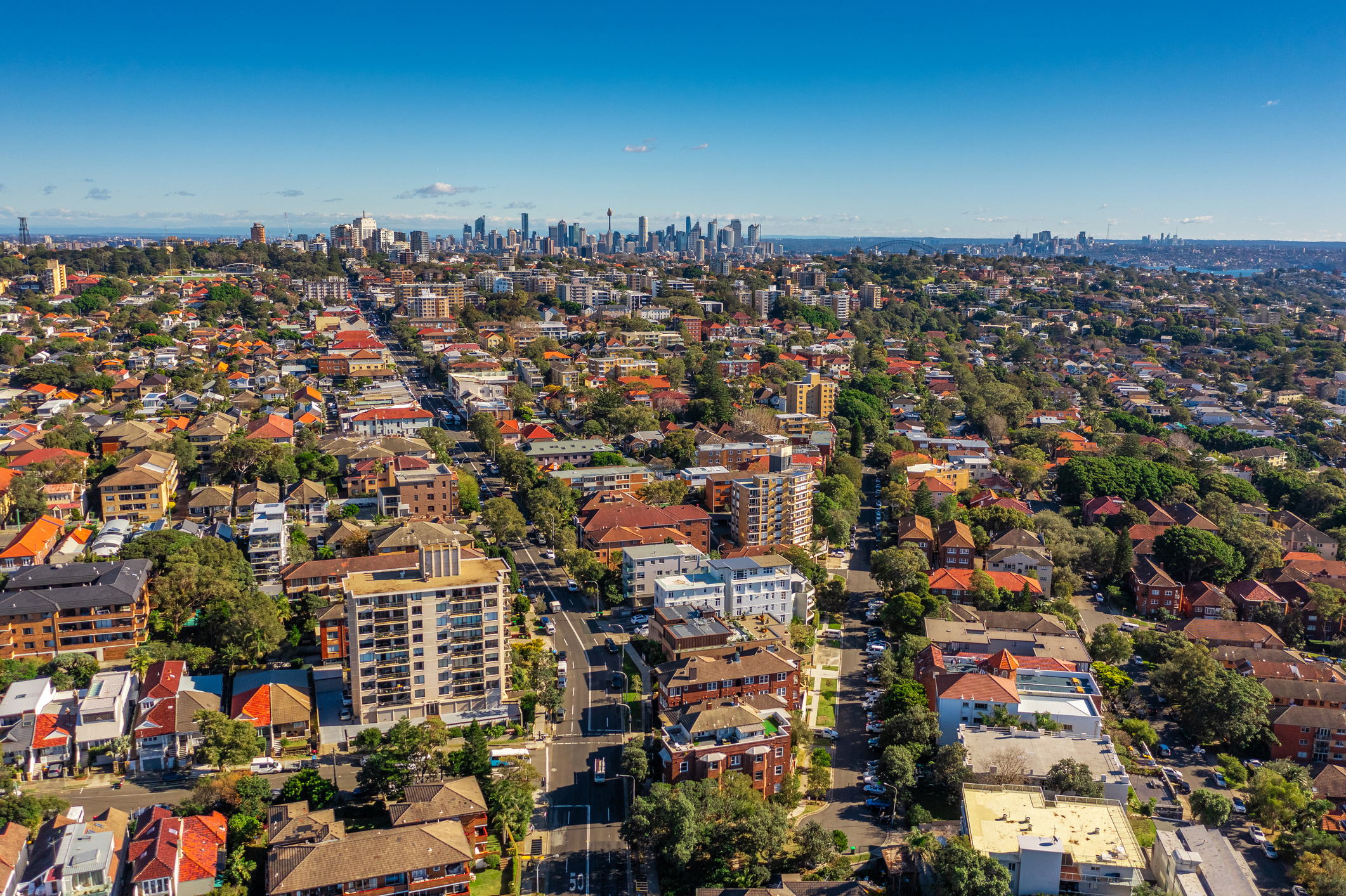 Bondi suburb in South Sydney. Drone aerial photo of Bondi with Sydney CBD and Harbour Bridge in the distance