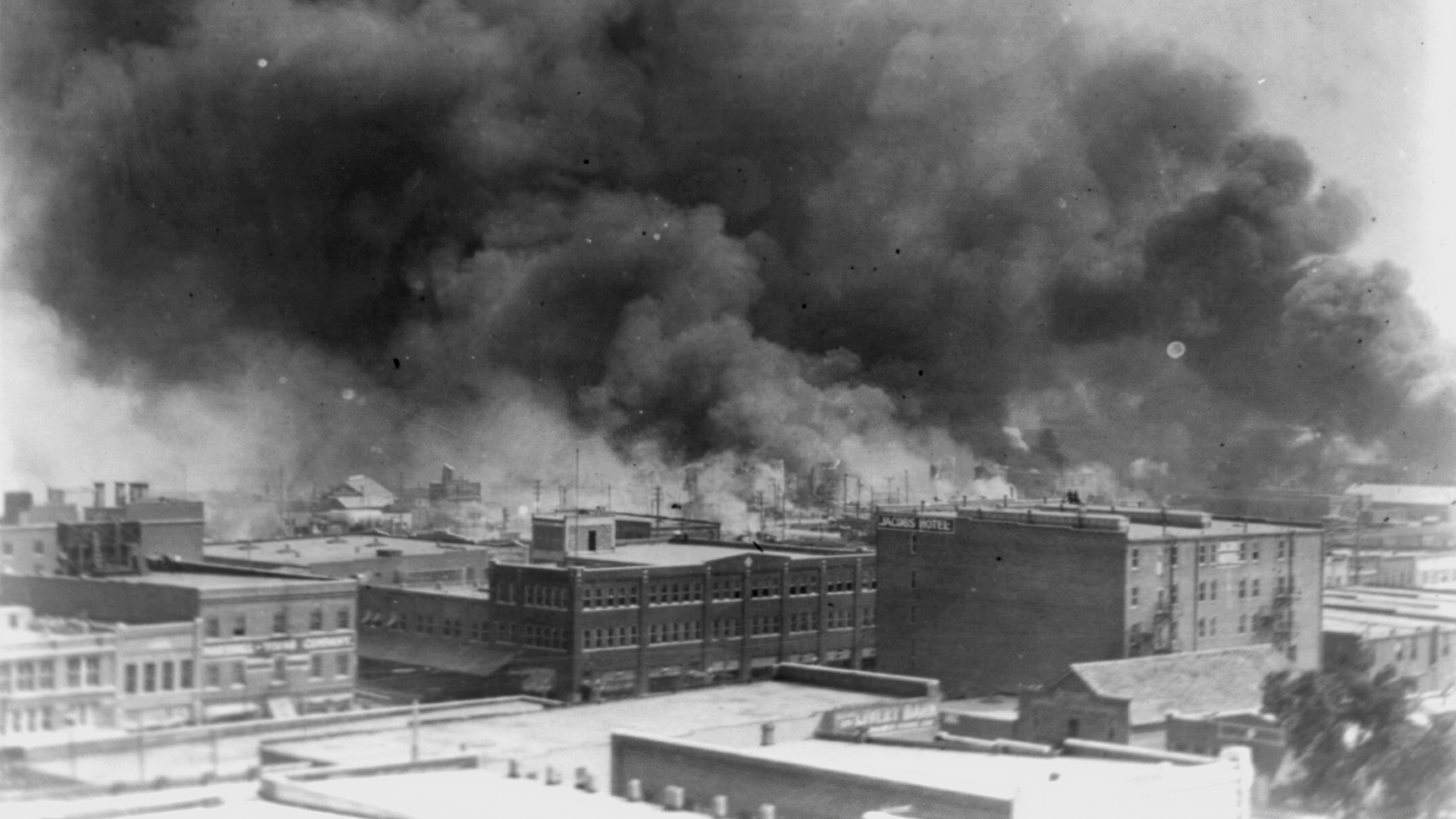 In this 1921 image provided by the Library of Congress, smoke billows over Tulsa, Oklahoma.
