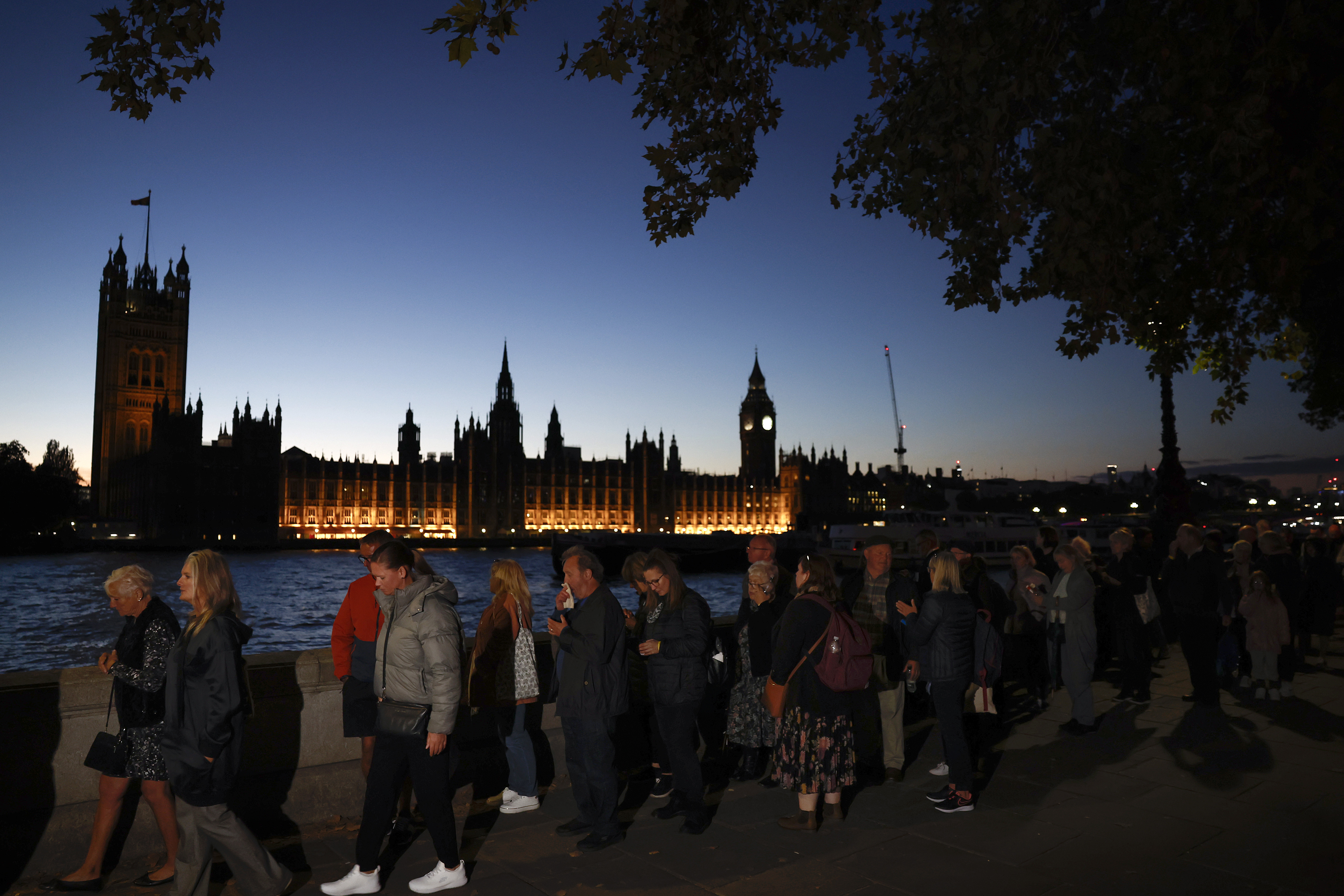 Members of the public stand in the queue in the evening for the Lying-in State of Queen Elizabeth II on September 16, 2022 in London, United Kingdom. Queen Elizabeth II is lying in state at Westminster Hall until the morning of her funeral to allow members of the public to pay their last respects. Elizabeth Alexandra Mary Windsor was born in Bruton Street, Mayfair, London on 21 April 1926. She married Prince Philip in 1947 and acceded to the throne of the Un