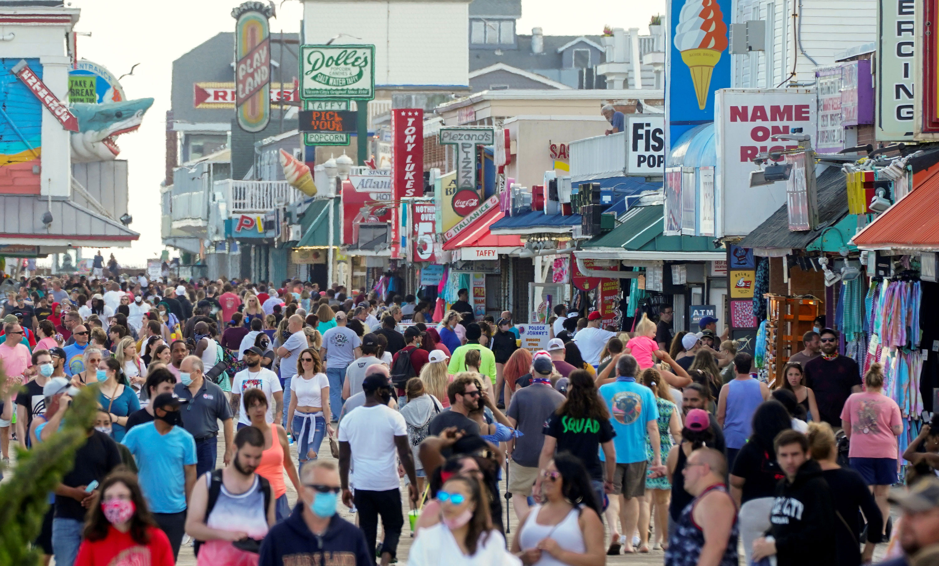 With the relaxing of coronavirus restrictions, visitors crowd the boardwalk on Memorial Day weekend in Ocean City, Maryland.