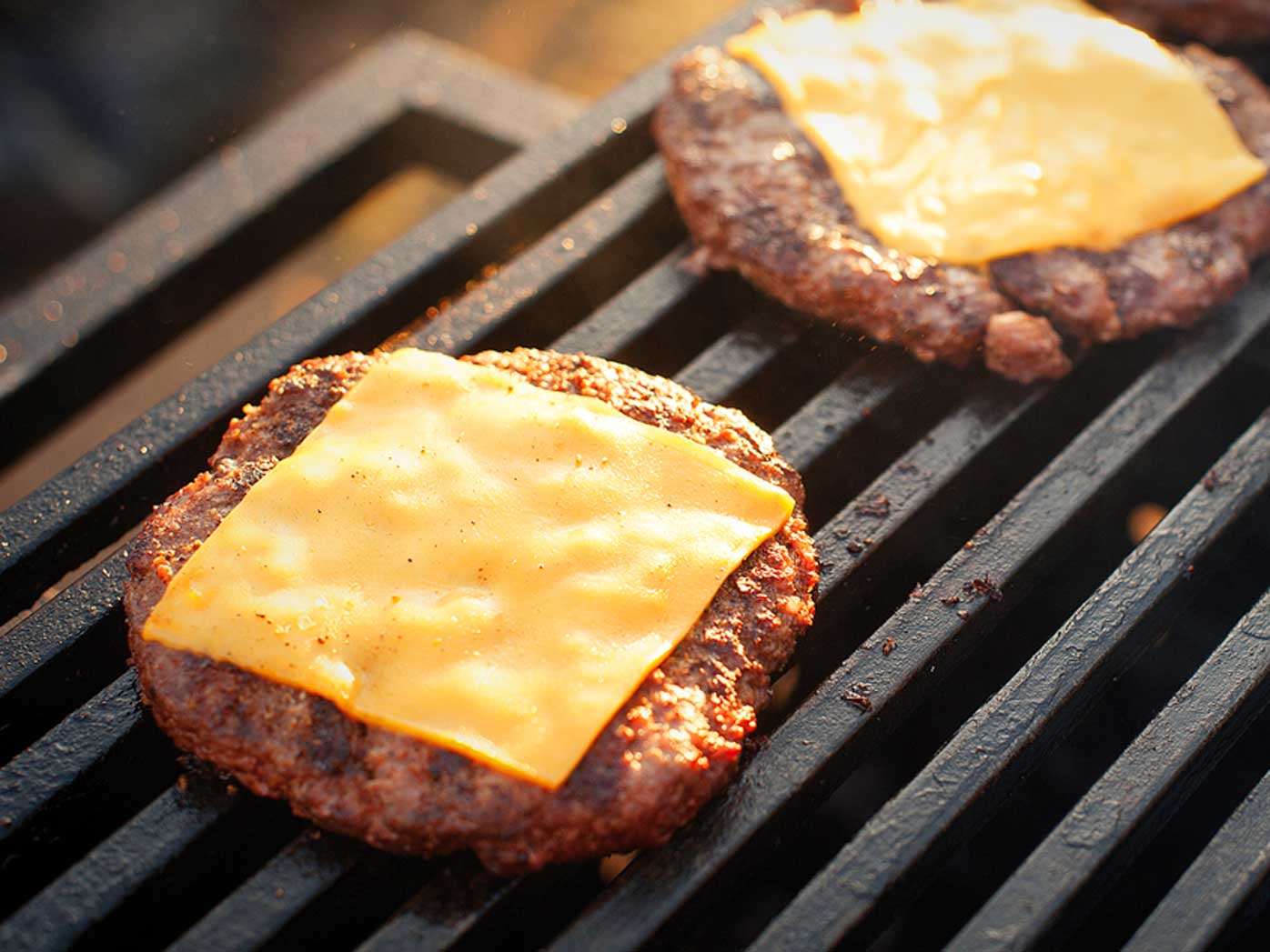 Grilling burger patties with cheese
