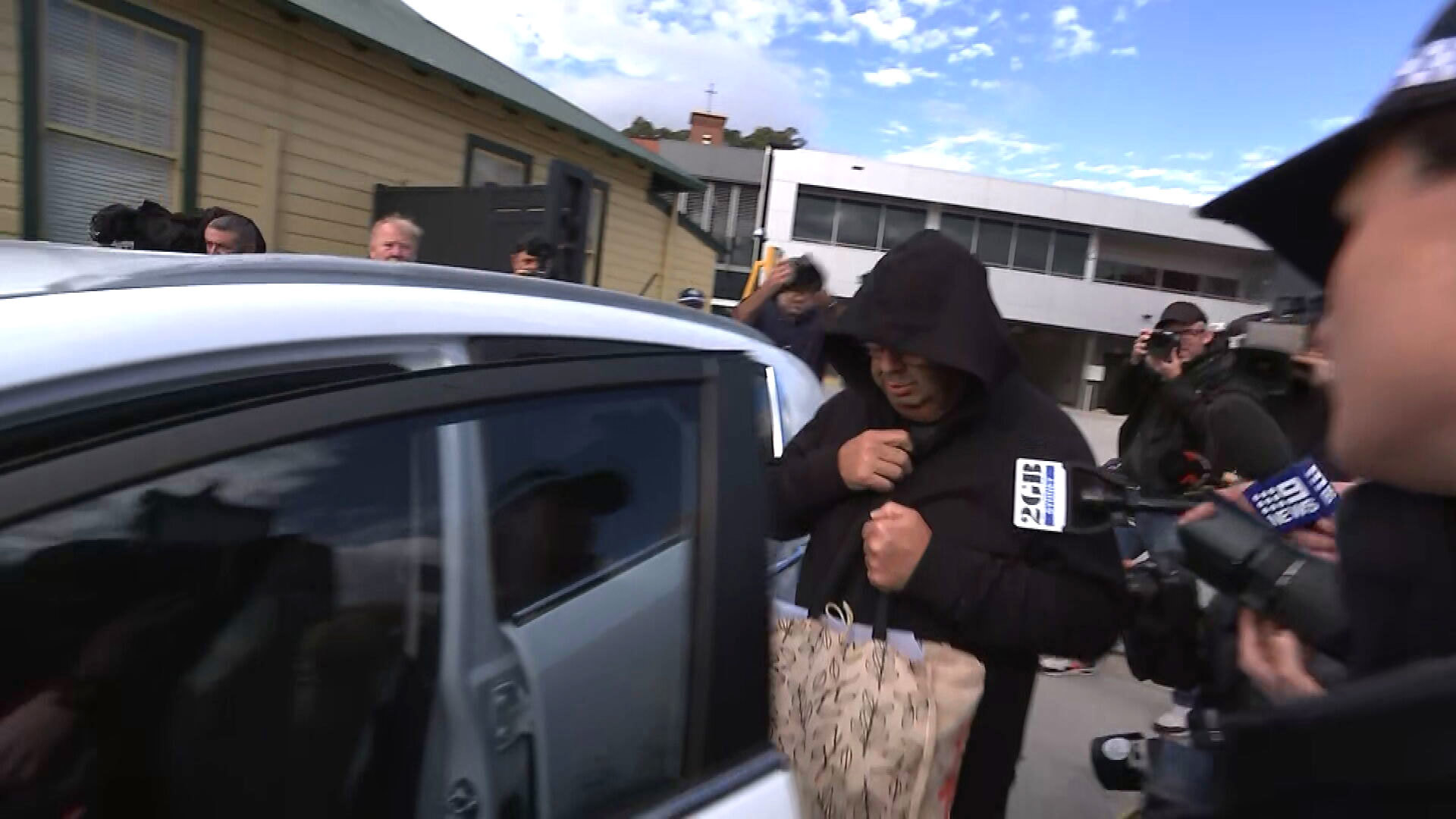 Brett Button leaves Cessnock Local Court on Tuesday morning, surrounded by media.