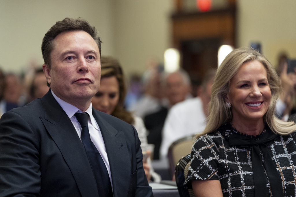 Elon Musk, left, sits with Kelly Johnson, wife of House Speaker Mike Johnson