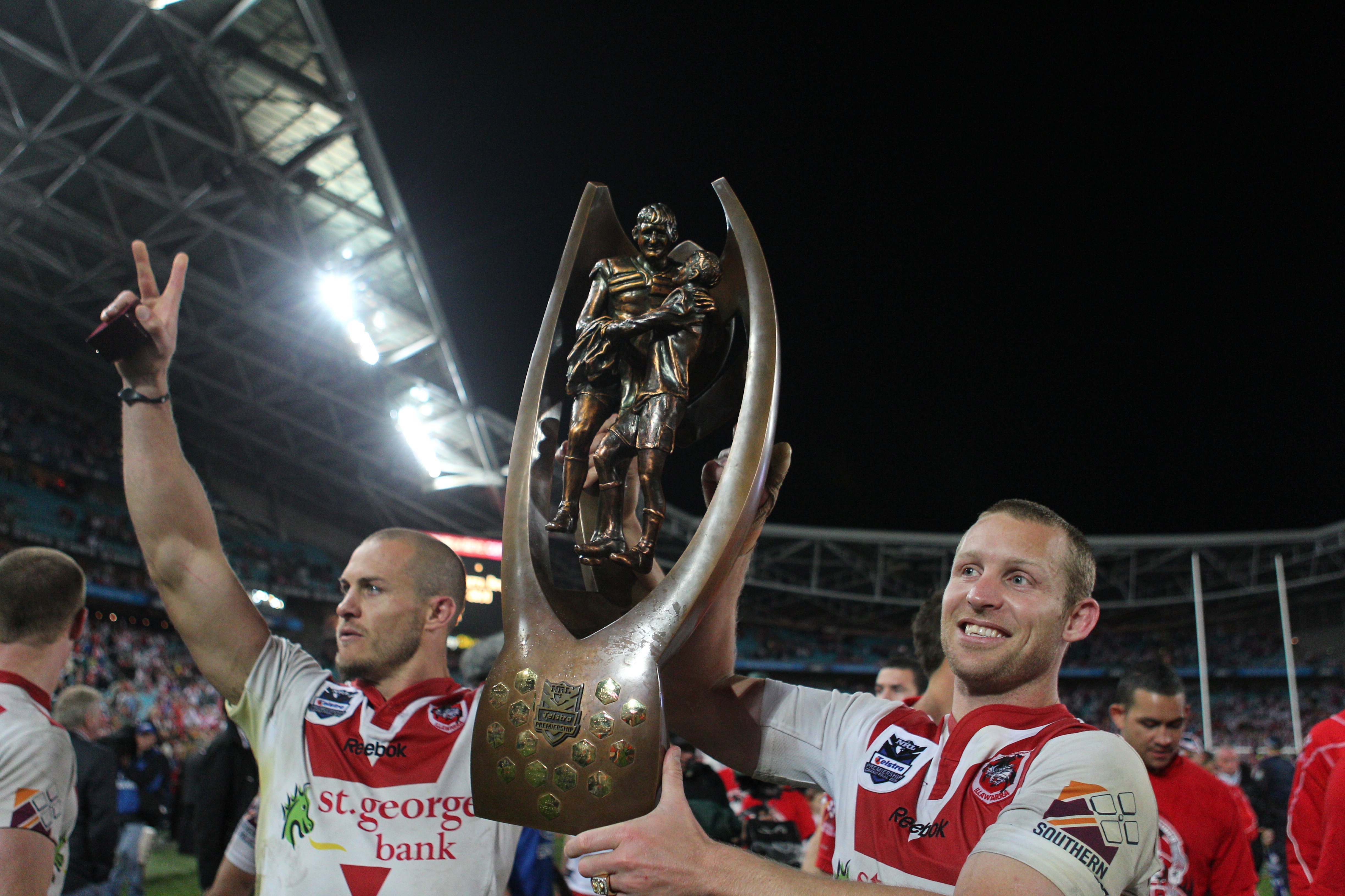 Ben Hornby (right) and Matt Cooper lift the NRL premiership trophy.