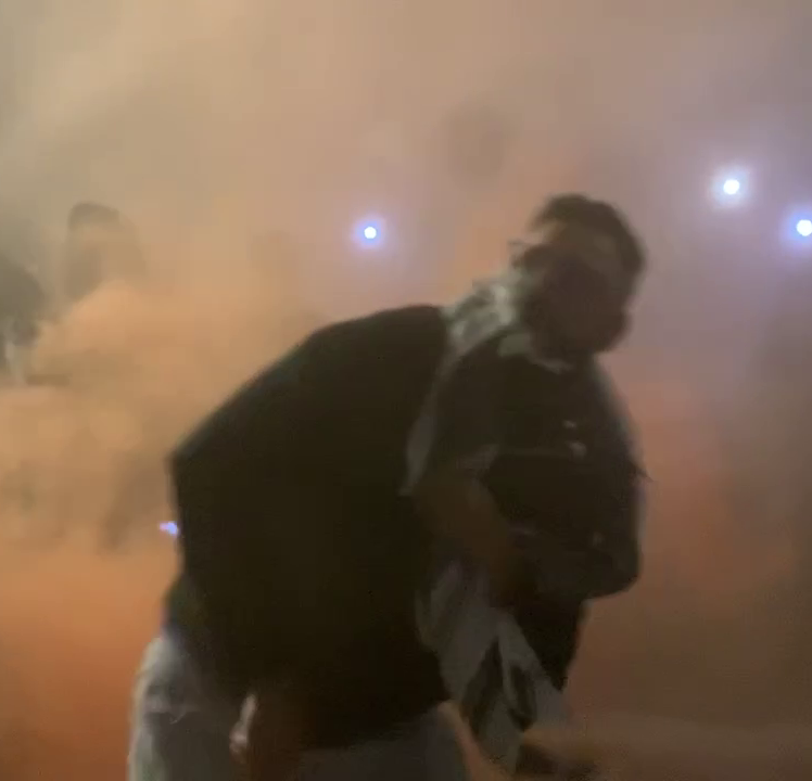 A man appears to throw a flare during a protest