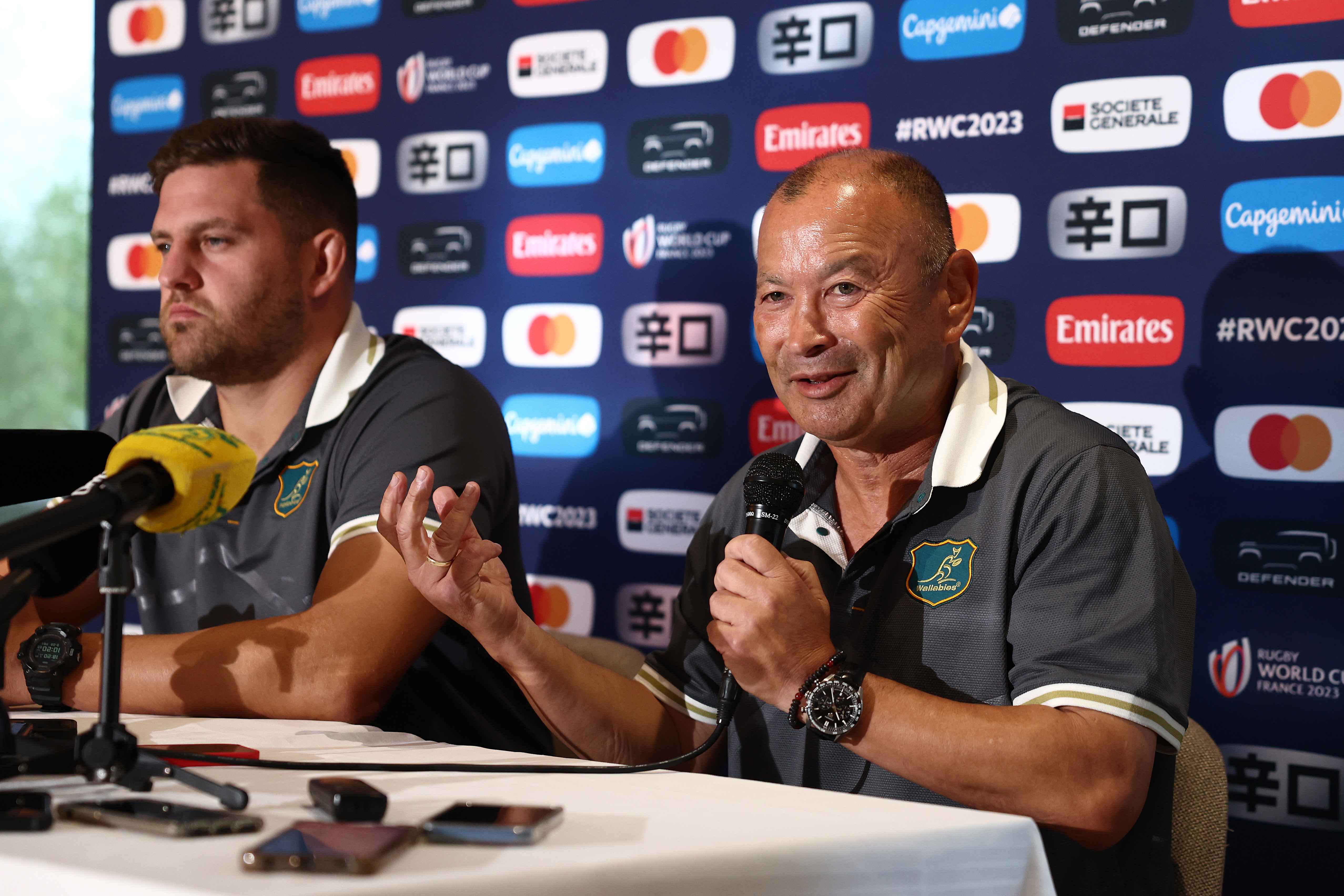 David Porecki (left) and head coach Eddie Jones speak to the media during a press conference.