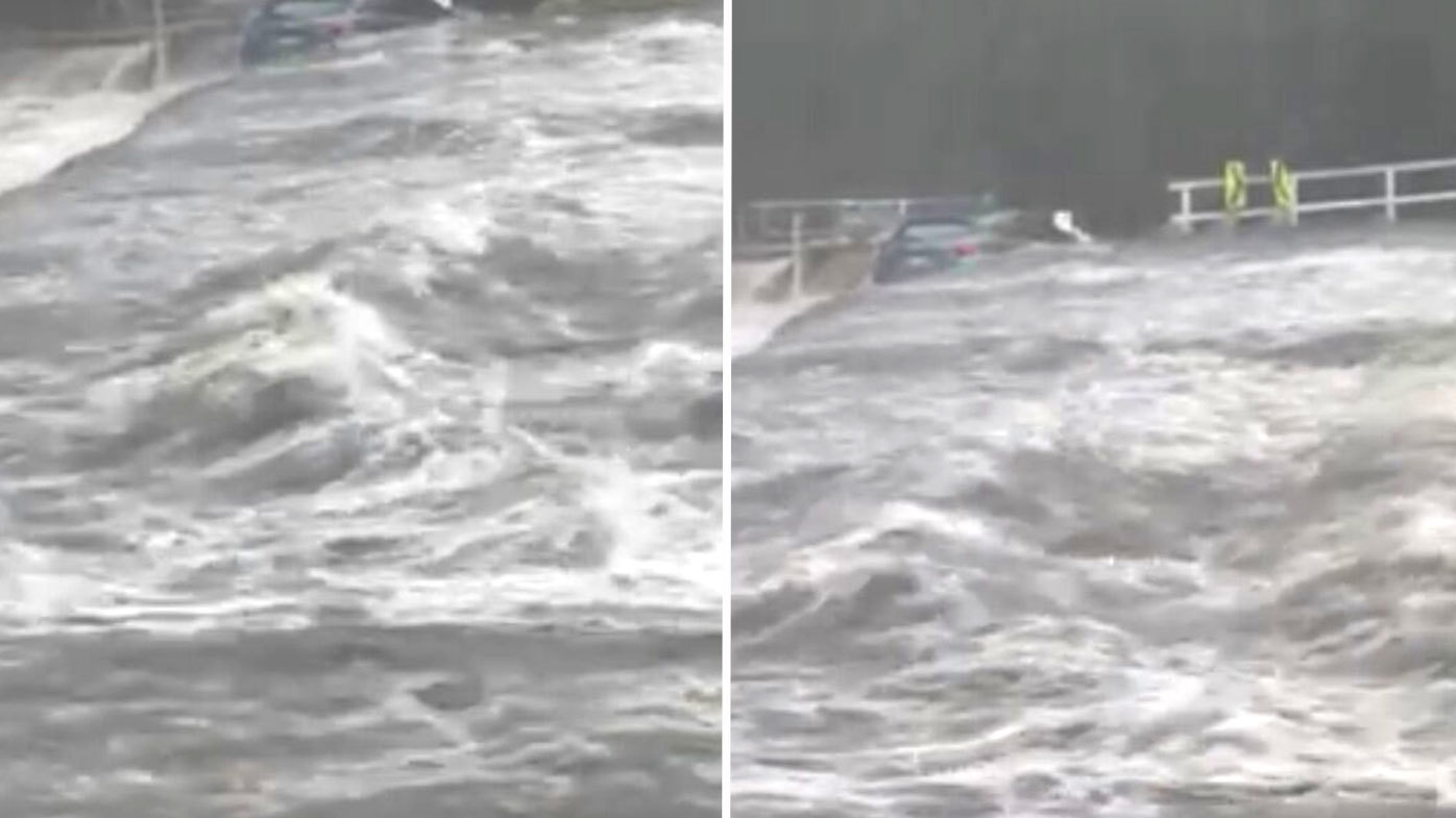 A car is swept off the weir in the Royal National Park during the severe thunderstorm in NSW.