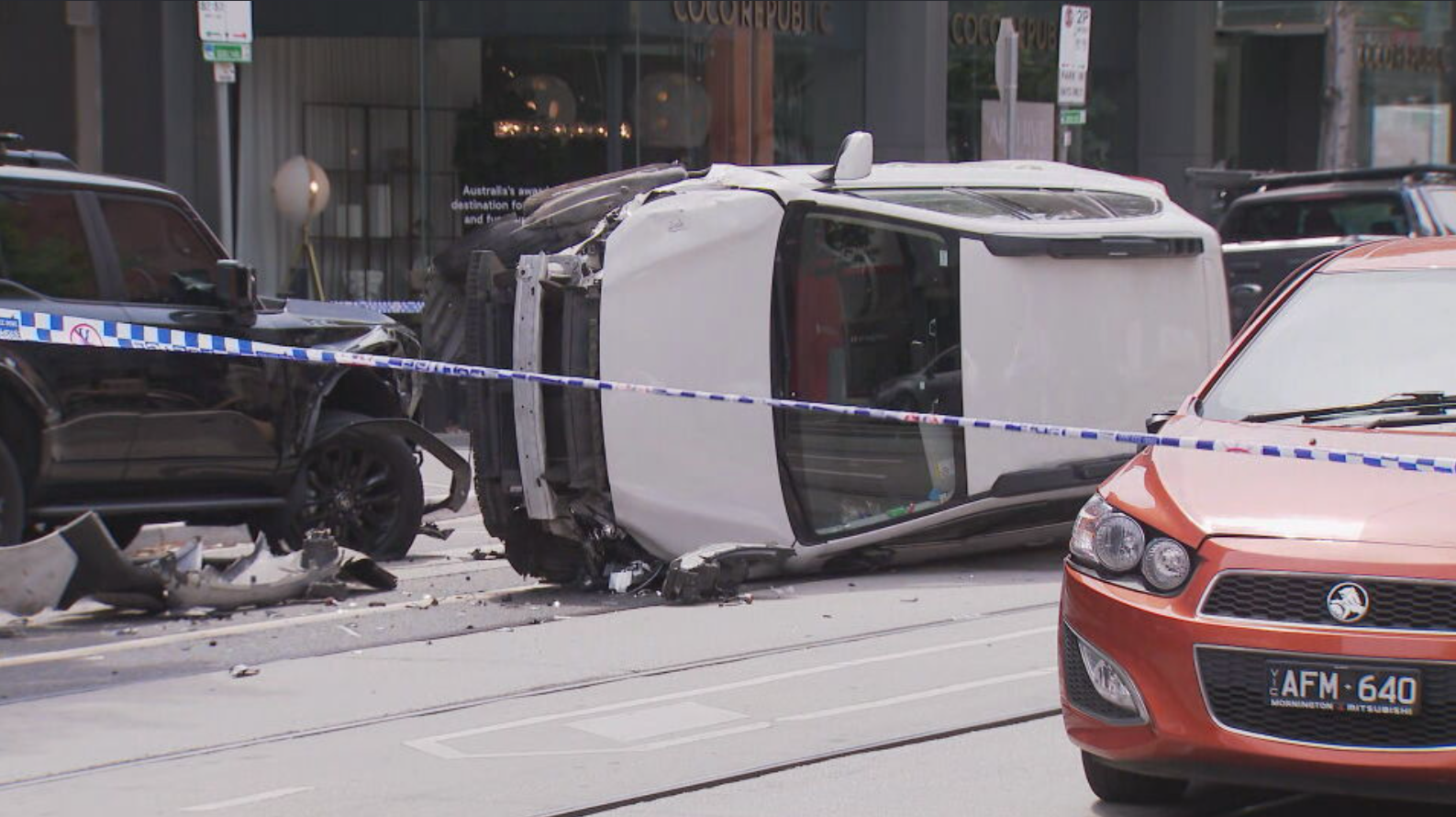 Two teenagers have been arrested after fleeing the scene when a car crashed and rolled on a busy inner-city street in Melbourne. 