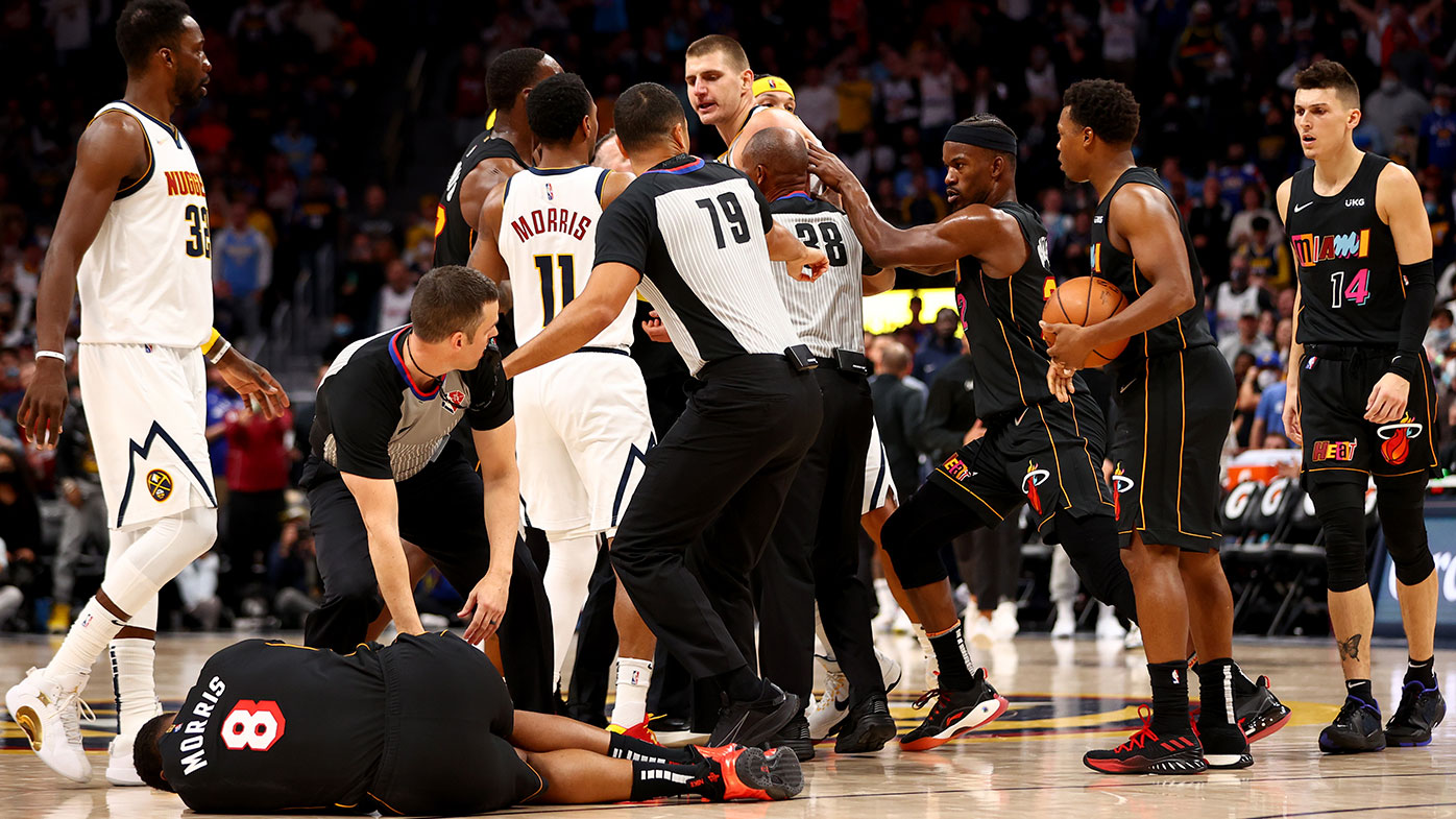 Markieff Morris #8 of the Miami Heat lays on the ground after being hit by Nikola Jokic #15 of the Denver Nuggets