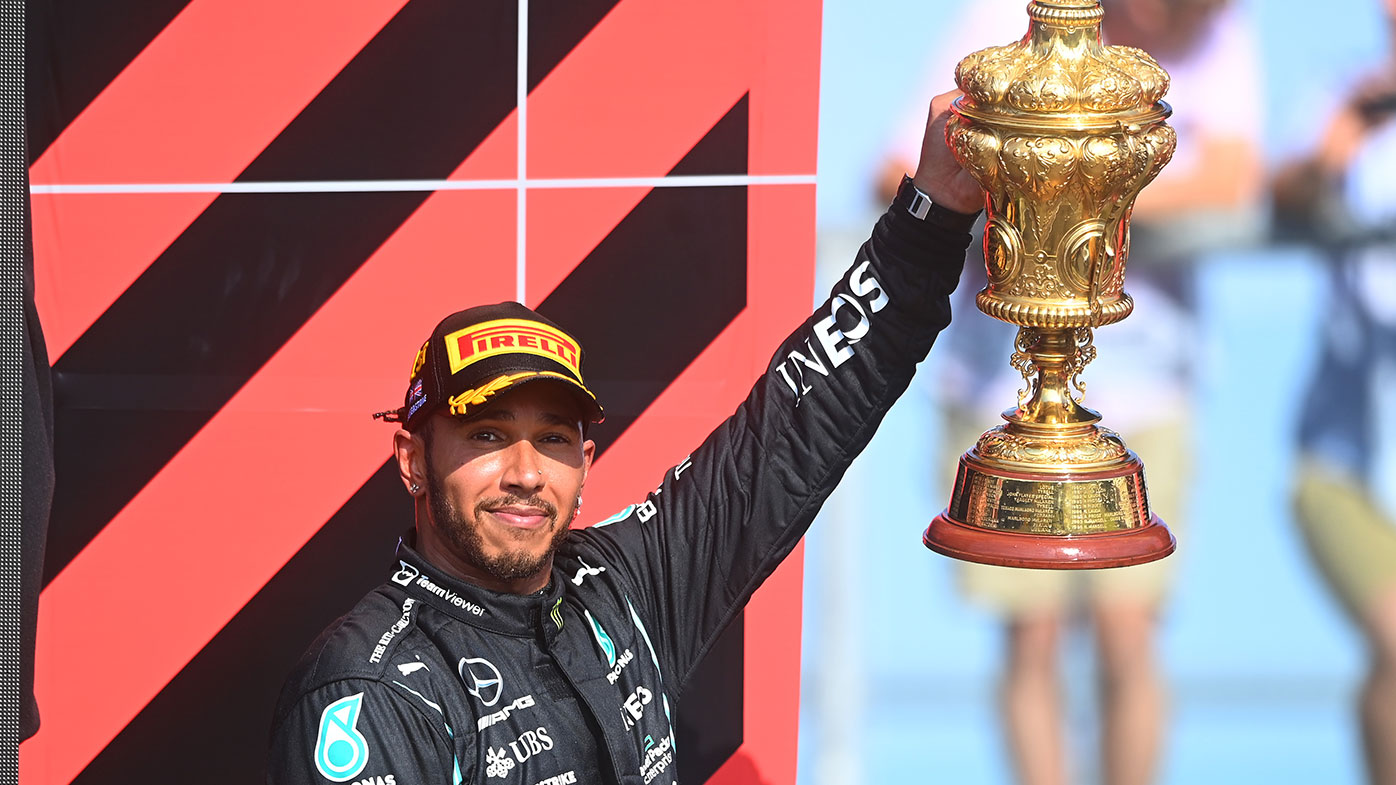 Lewis Hamilton lifts the British Grand Prix trophy.