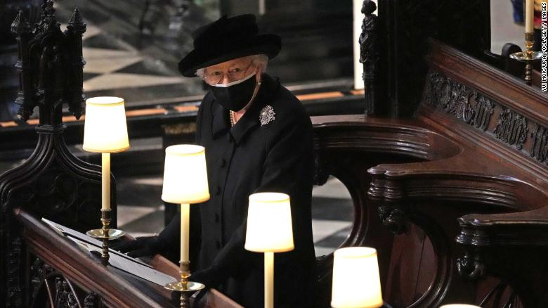 Queen Elizabeth II watches as pallbearers carry the coffin of Prince Philip, Duke Of Edinburgh into St. George's Chapel at Windsor Castle on April 17, 2021.