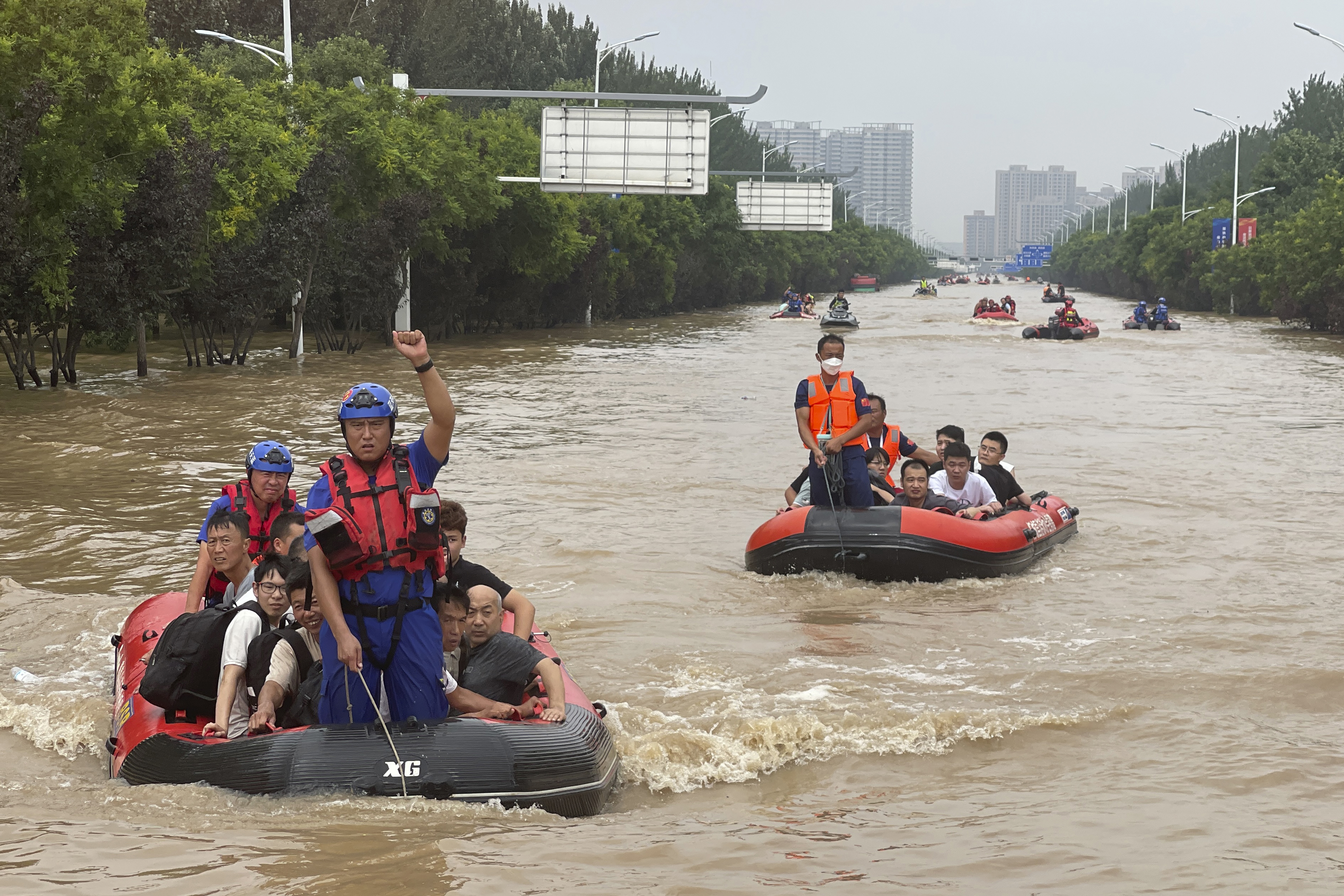 Residents are evacuated by rubber boats through flood waters in Zhuozhou in northern China's Hebei province, south of Beijing on Wednesday.