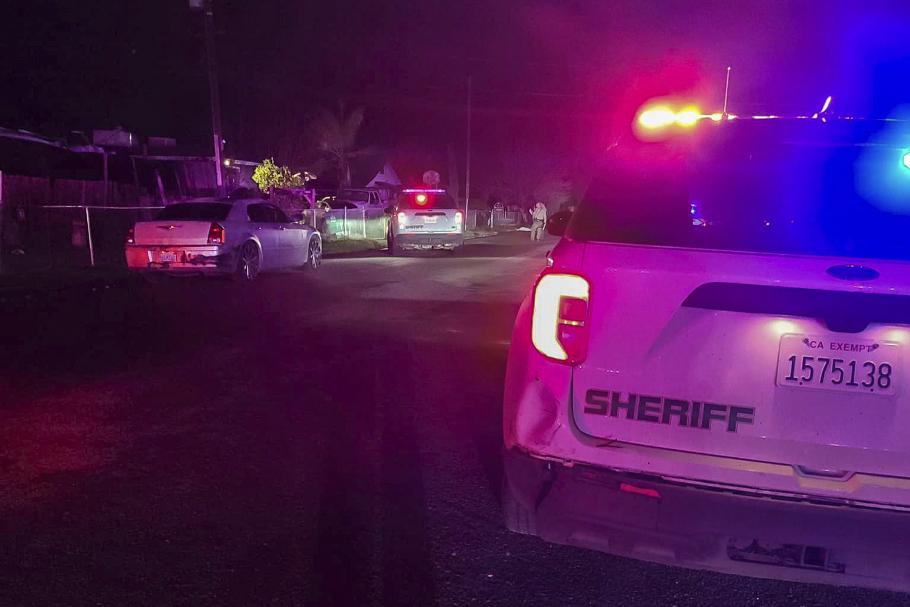 Detectives investigate a shooting in Goshen near Visalia, California, early morning Monday, Jan. 16, 2023.