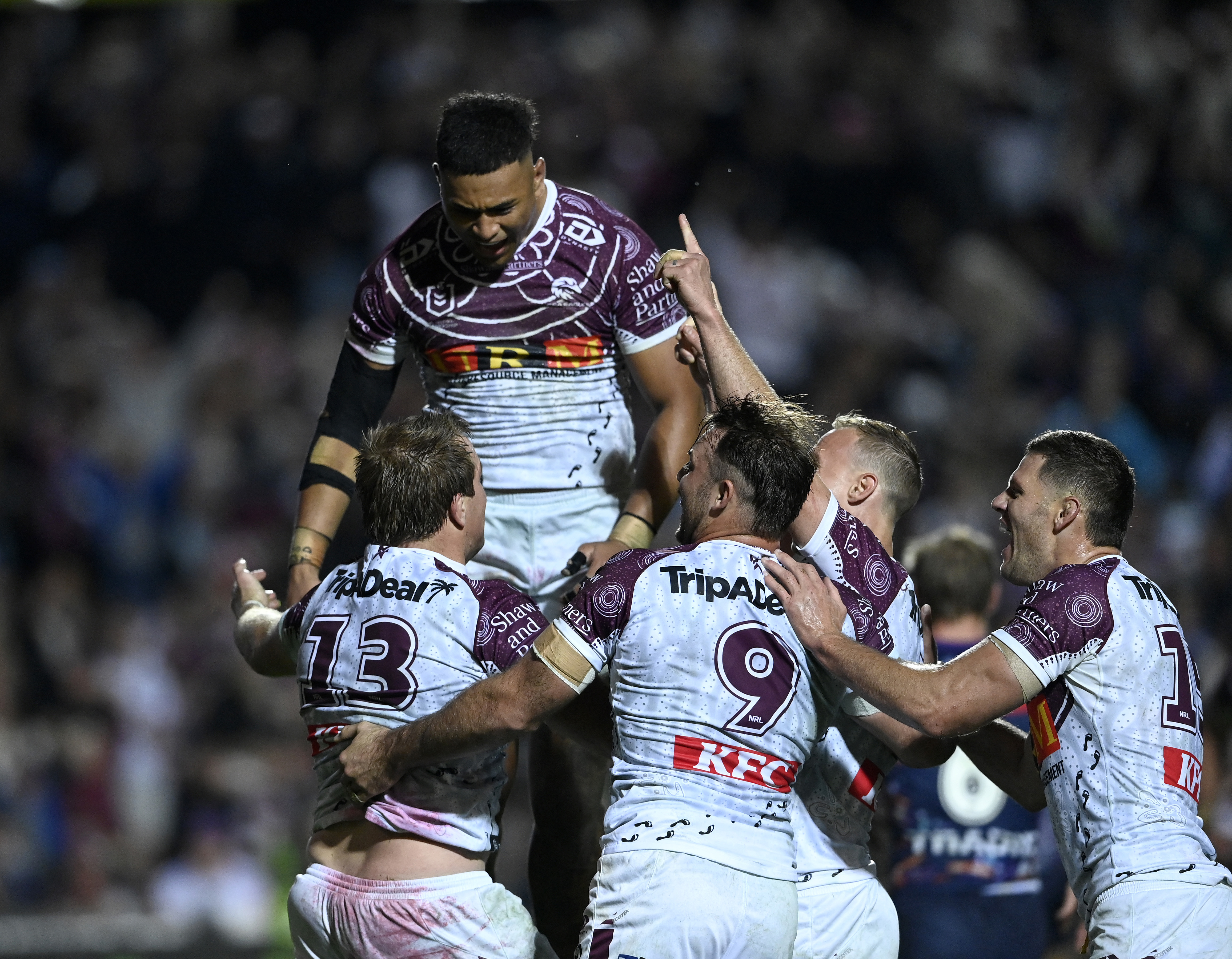 Manly players celebrate Jake Trbojevic's second half try against the Storm.