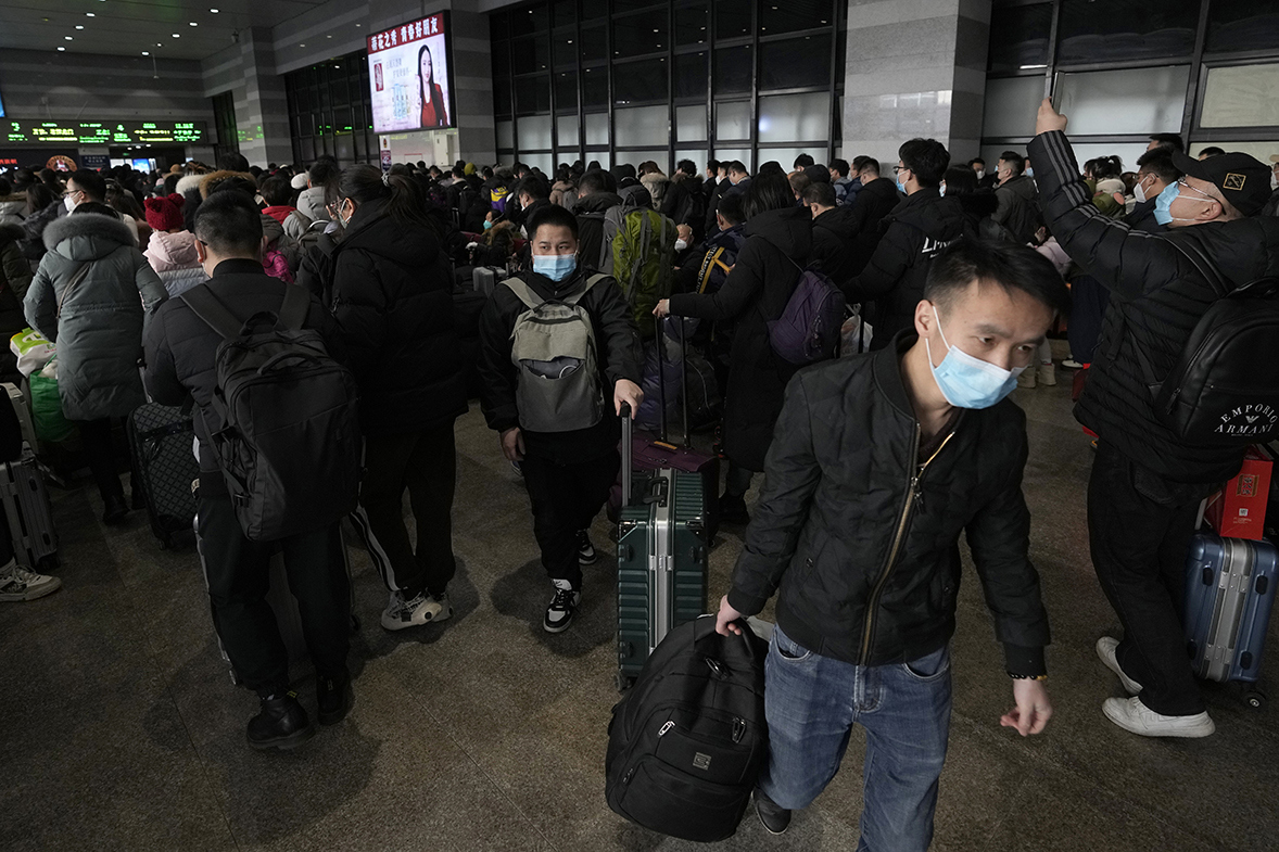 Travelers with their luggage arrive at a departure hall to catch their trains at the West Railway Station in Beijing