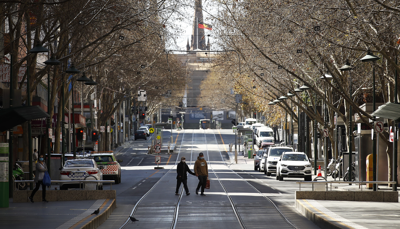 A woman is seen exercising along a quiet Bourke Street on September 06, 2020 in Melbourne, Australia. 
