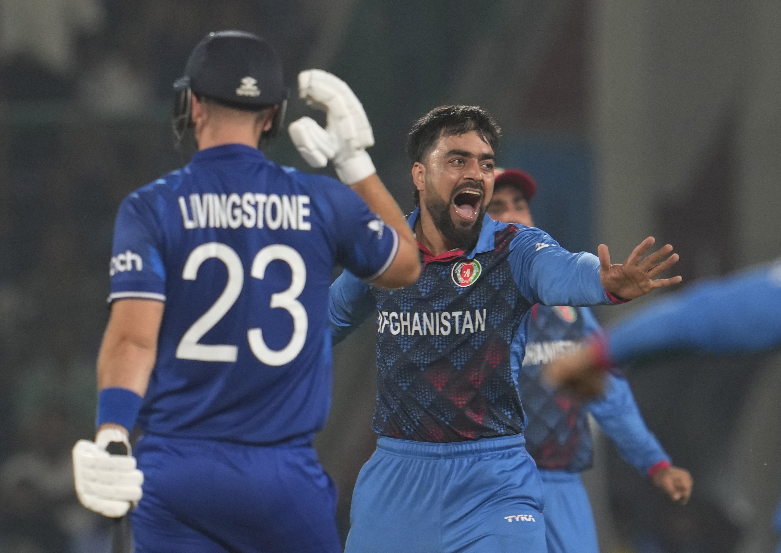 Afghanistan's Rashid Khan celebrates the wicket of England's Liam Livingstone.