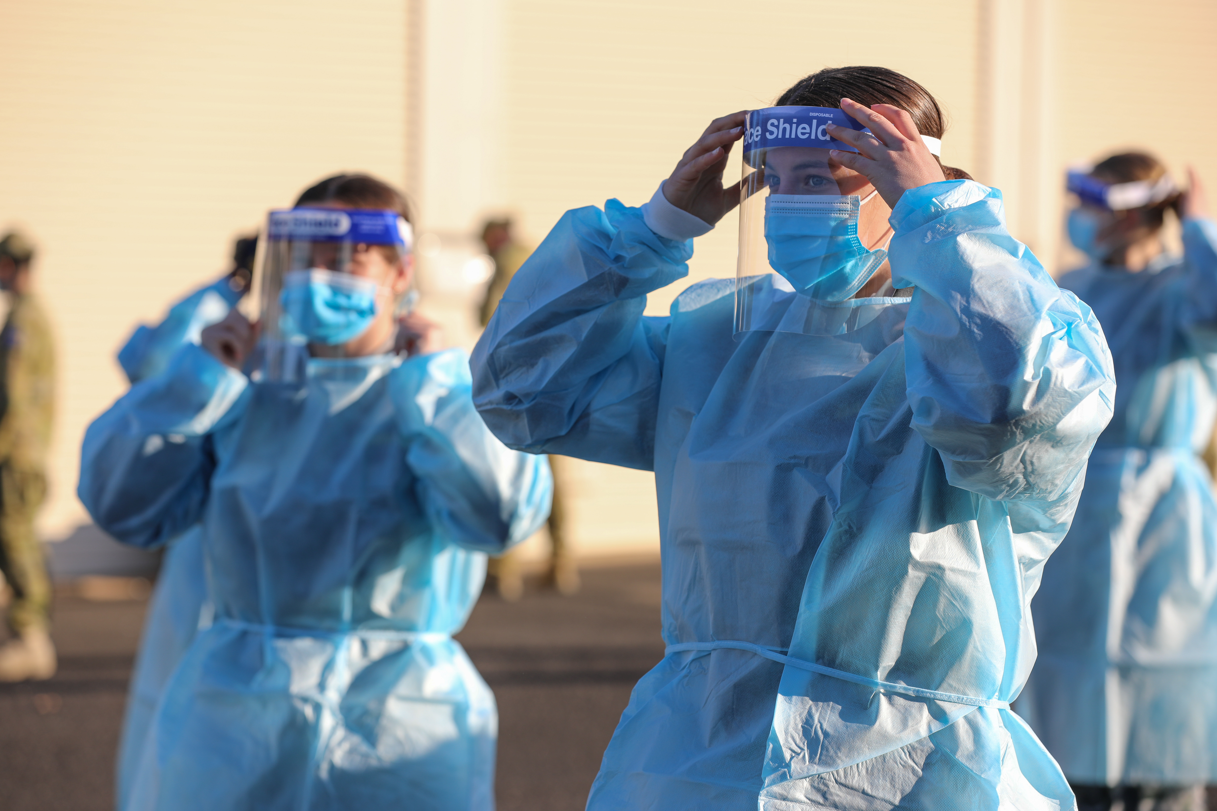 Australian Defence Force members Seaman Chloe Baker and Seaman Tamsin Conway practice correct application of Personal Protective Equipment (PPE) in preparation for their deployment in Task Unit 3, on the Joint Task Force 629.2, Operation COVID-19 Assist