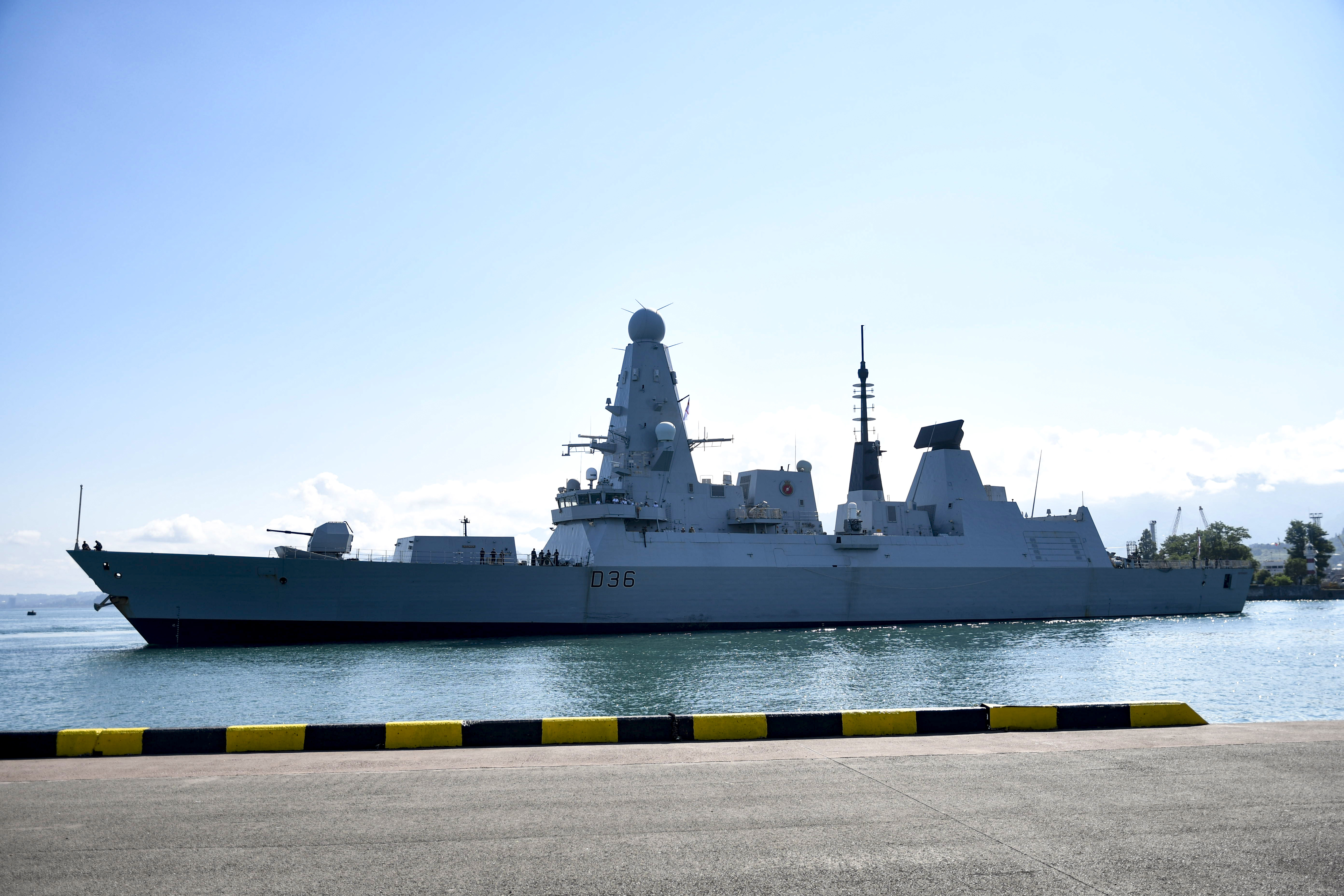 British destroyer HMS Defender arrives at the port of Batumi, in Georgia, on June 26, 2021. Moscow said one of its warships fired warning shots and a warplane dropped bombs in the path of British destroyer Defender last week to force her out of an area near Crimea that Russia claims as its territorial waters. Britain denied that account.