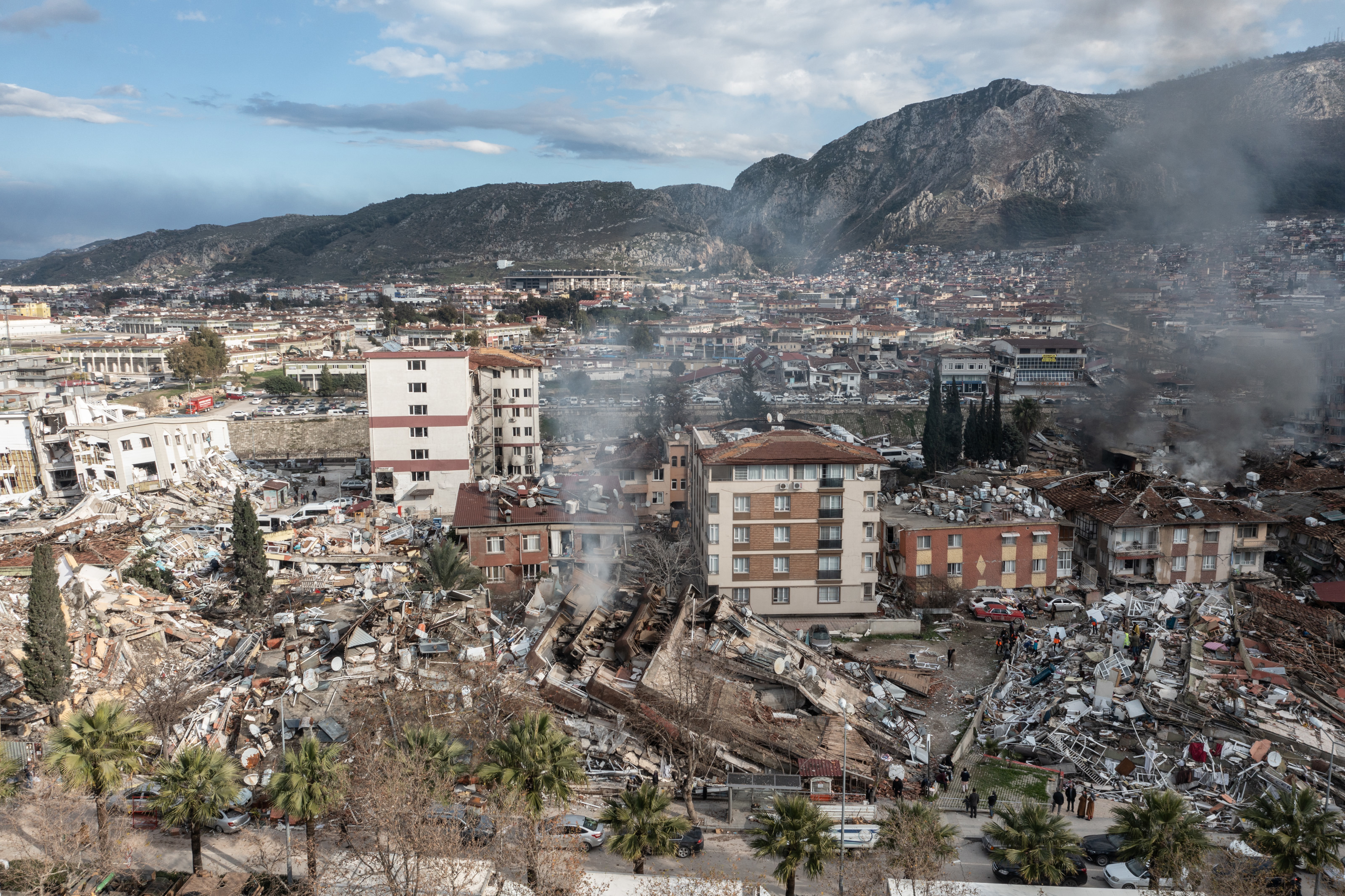 Smoke billows from the scene of a collapsed buildings on February 07, 2023 in Hatay, Turkey.