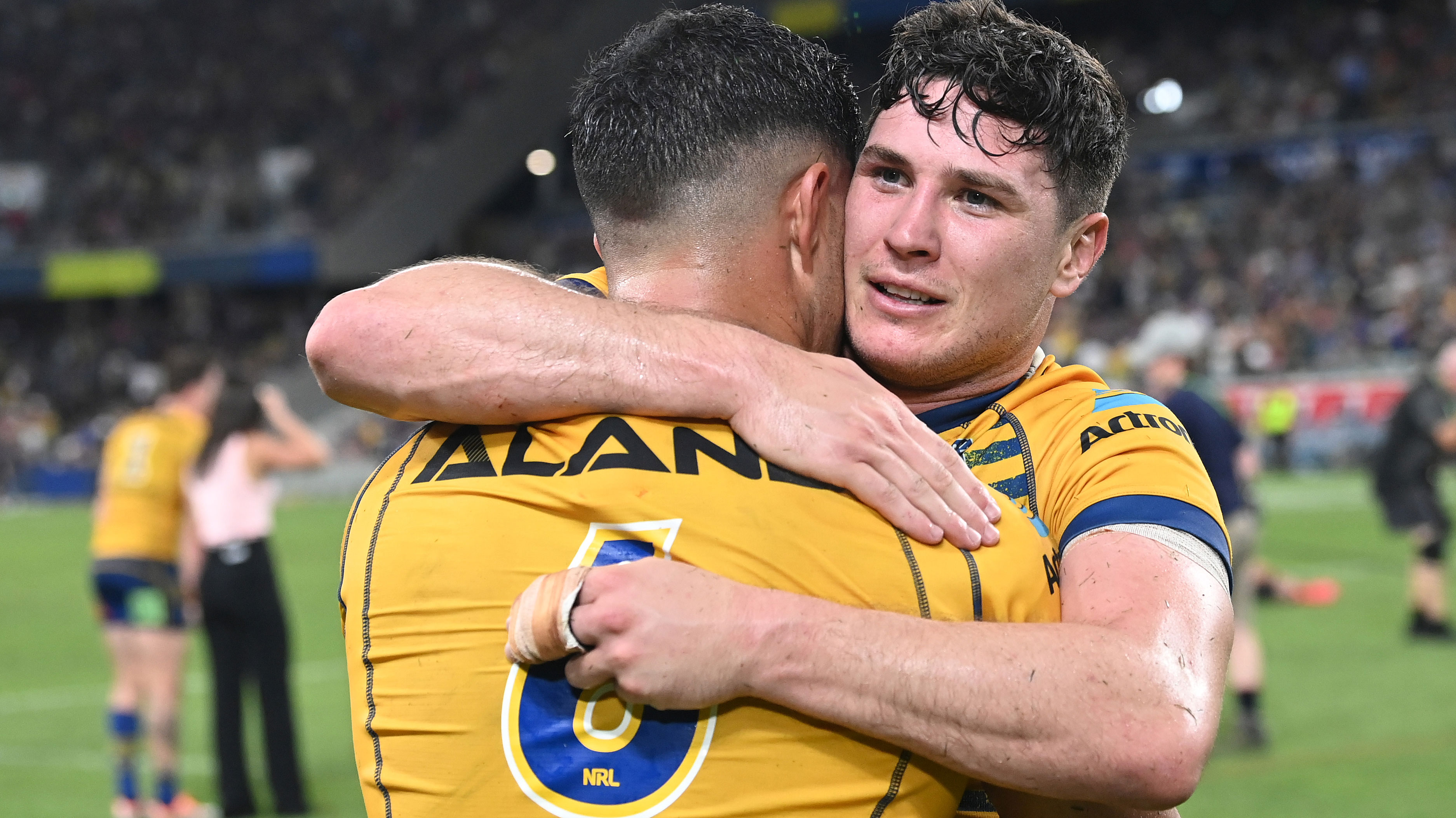 Mitchell Moses embraces Eels halves partner Dylan Brown after their preliminary final win over the Cowboys.
