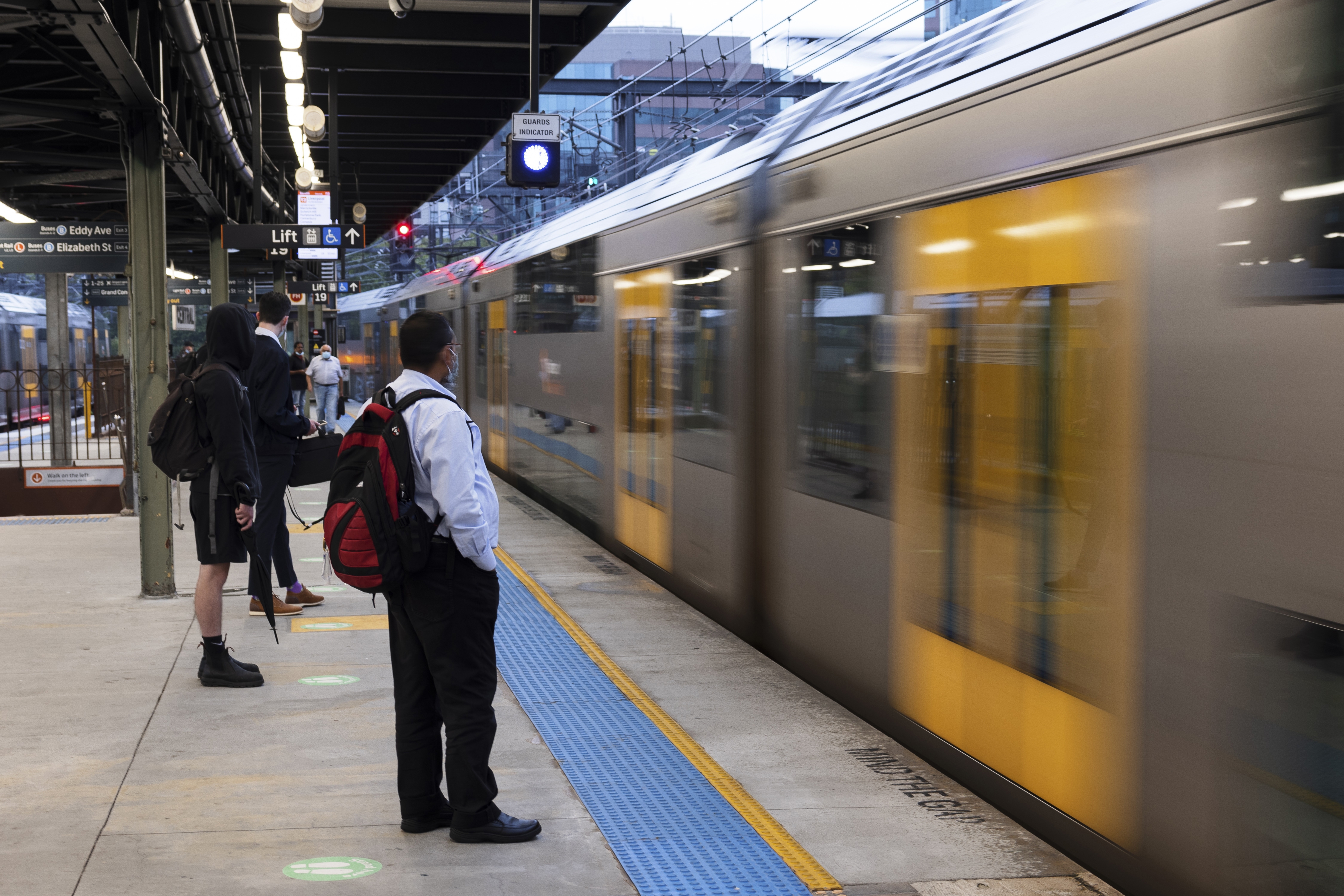 Early morning commuters at Central Station. Metro trains are back running at reduced capacity today, with services on most lines departing every 30 minutes. 22 February, 2022. Photo: Brook Mitchell