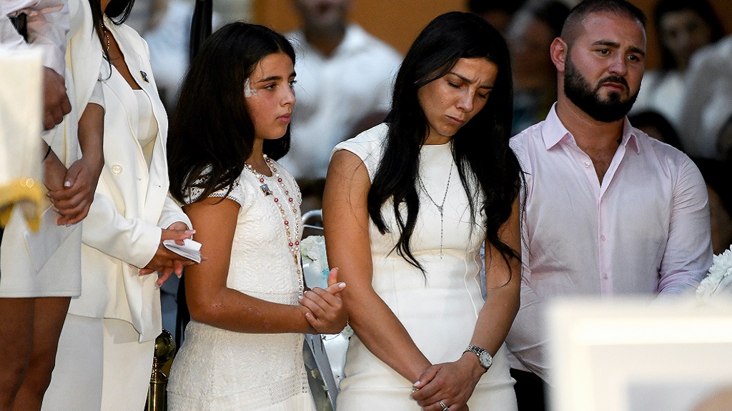 Leila Geagea (middle) and daughter (left) are seen during the funeral for her three children. 