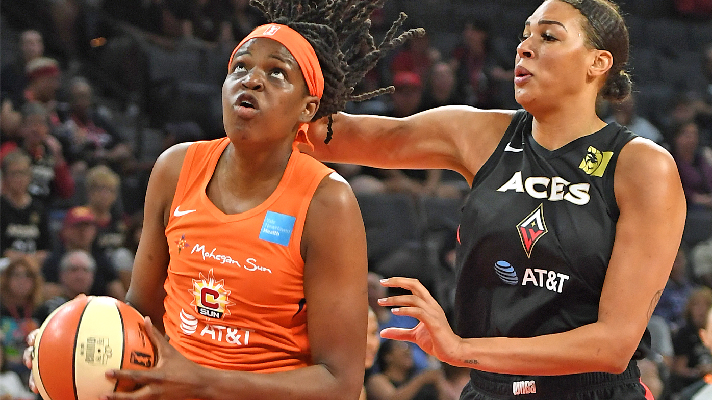 Jonquel Jones #35 of the Connecticut Sun drives to the basket against Liz Cambage #8 of the Las Vegas Aces