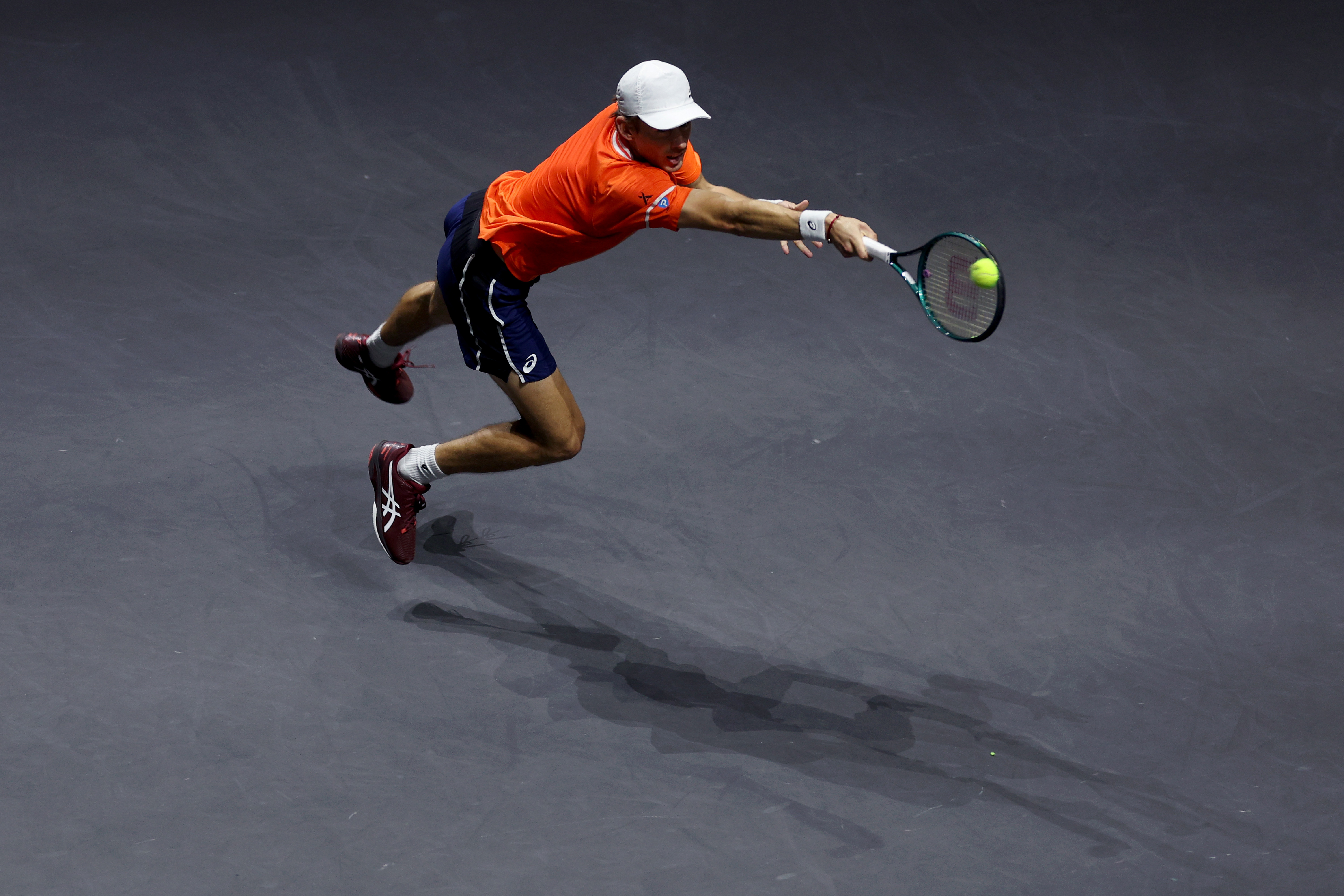 Alex de Minaur of Australia returns a backhand against Jannik Sinner of Italy.