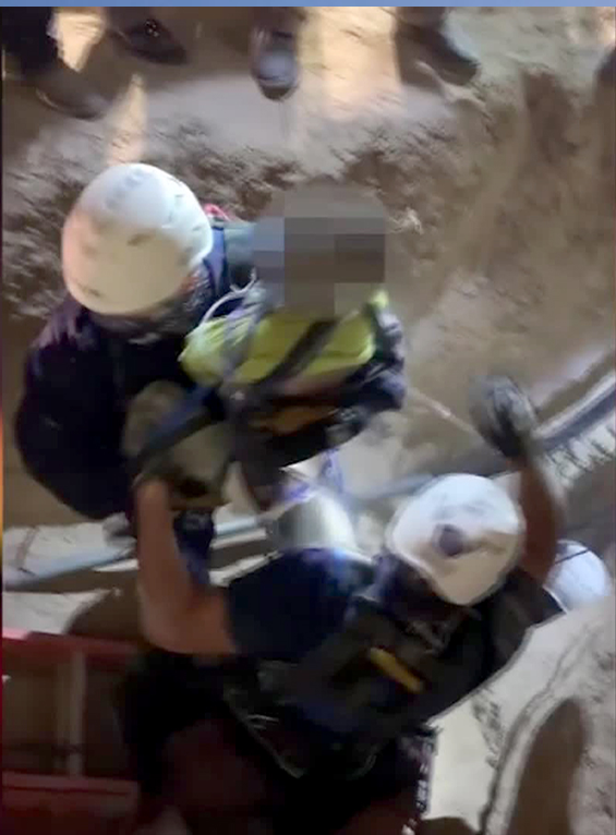 A frame from a video released by the City of Mission, Texas, shows a boy being rescued from a well. The boy's face was obscured at the time of release.