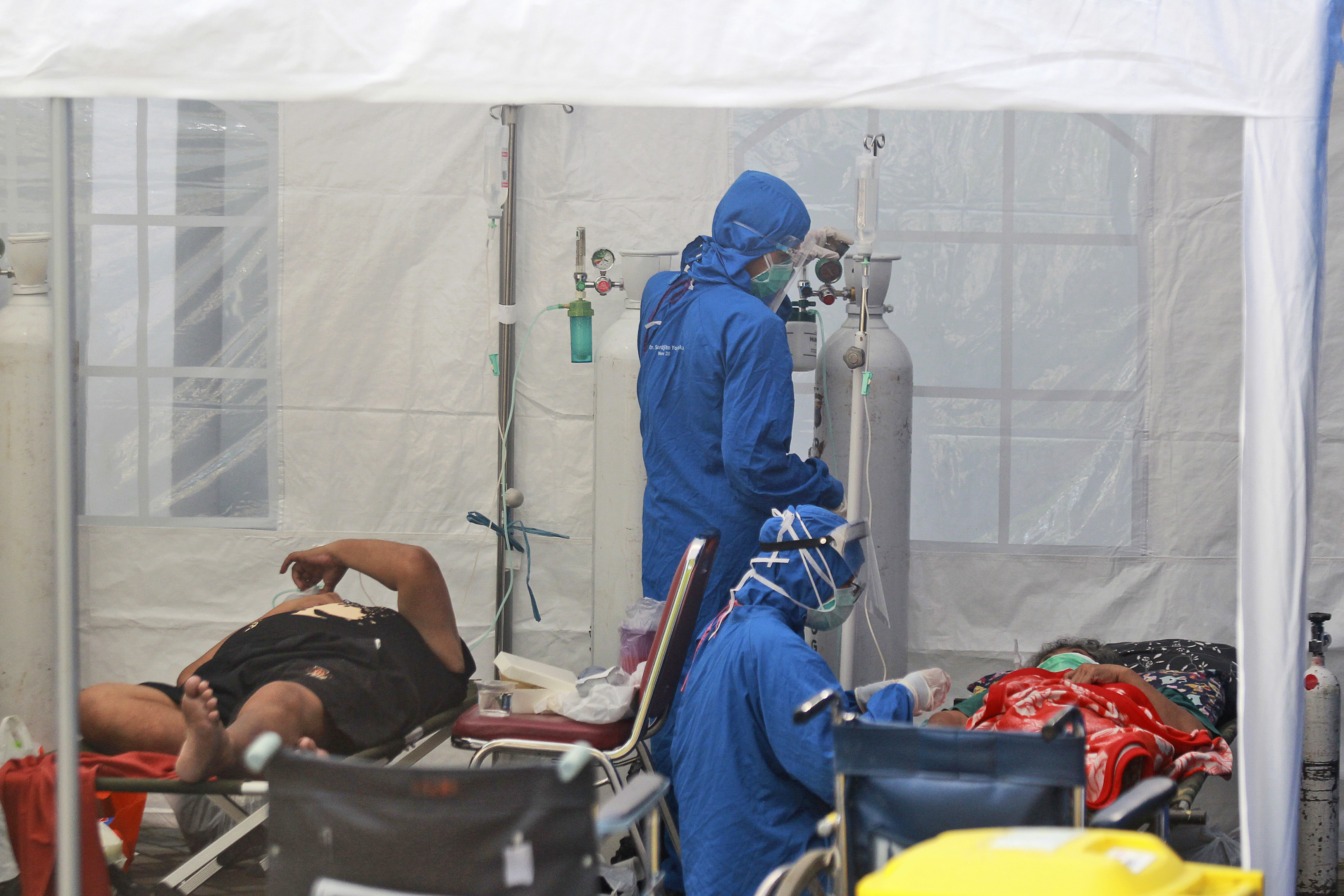 Medical workers treat patients inside an emergency tent erected to accommodate a surge in COVID-19 cases, at Dr. Sardjito Central Hospital. (AP Photo/Kalandra)