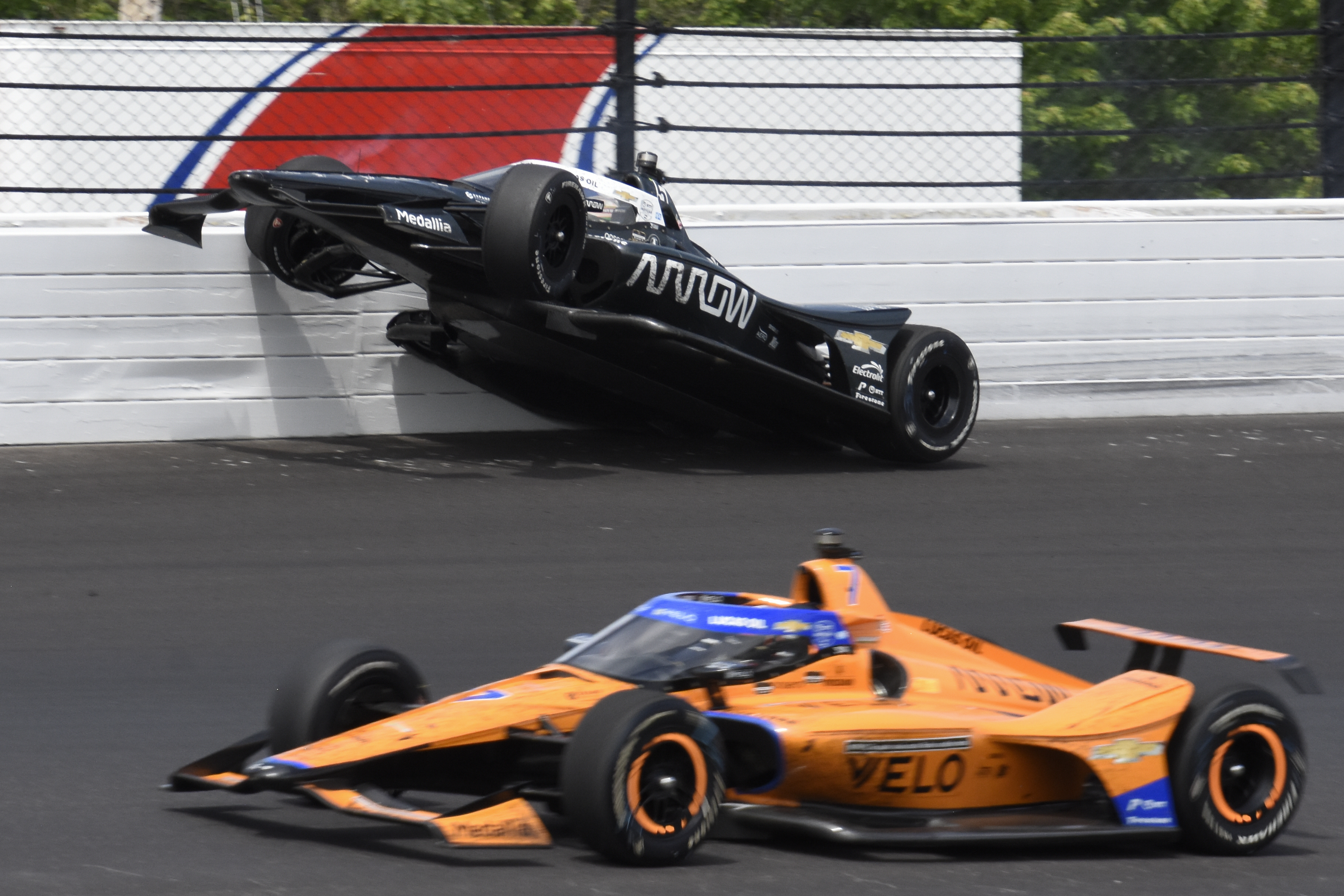 Pato O'Ward hits the wall in the third turn during the Indianapolis 500.