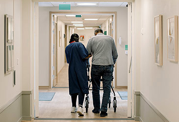 Stock image of nurse assisting resident in aged care home (Getty)