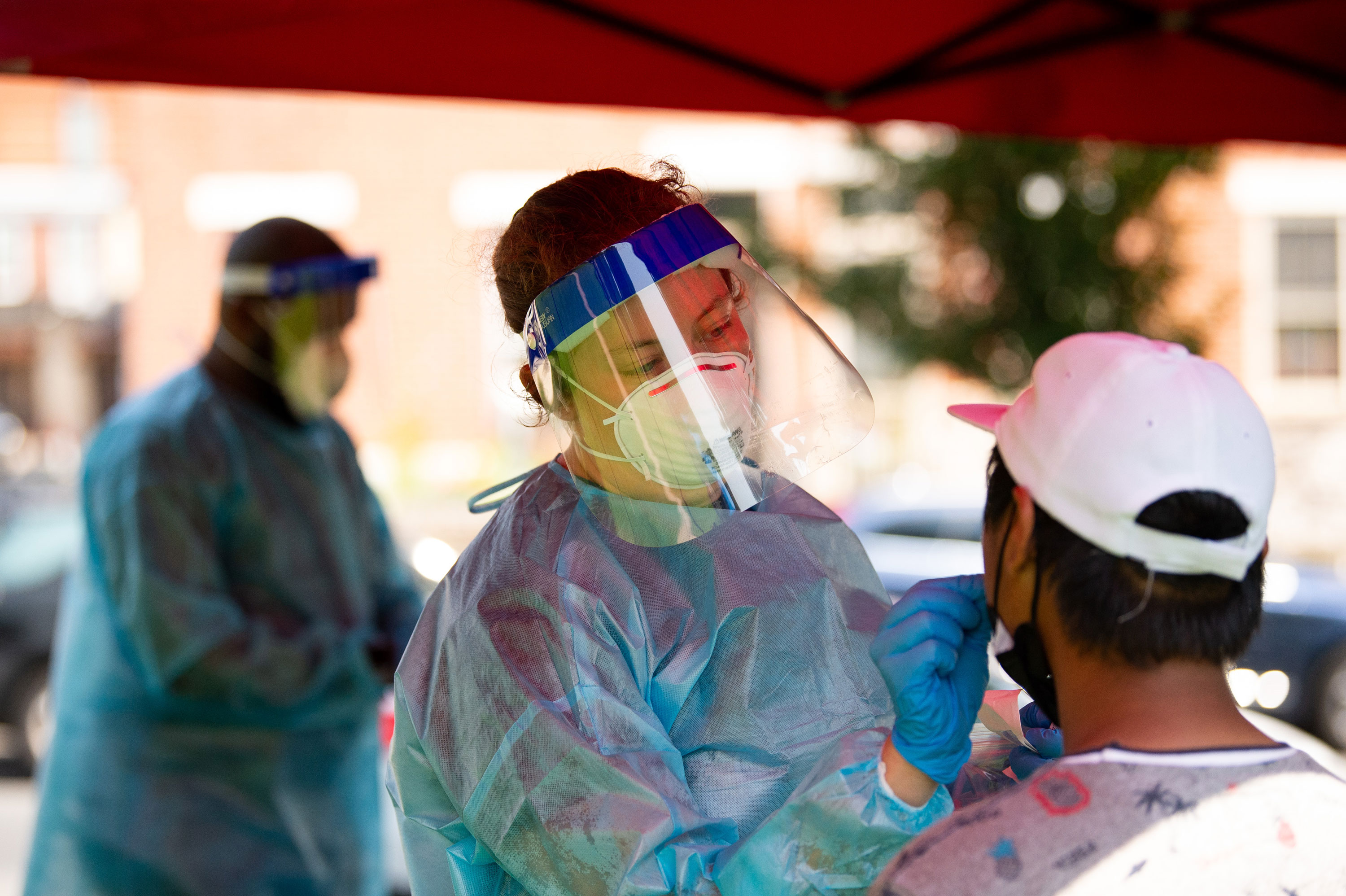 A healthcare worker administers a Covid-19 test at a testing site in Mifflin Square Park in Philadelphia, Pennsylvania, U.S., on Thursday, Aug. 12, 2021. The City of Philadelphia issued new mask mandates to protect against the Delta variant, requiring masks to be worn indoors and at large outdoor gatherings. Photographer: Kriston Jae Bethel/Bloomberg