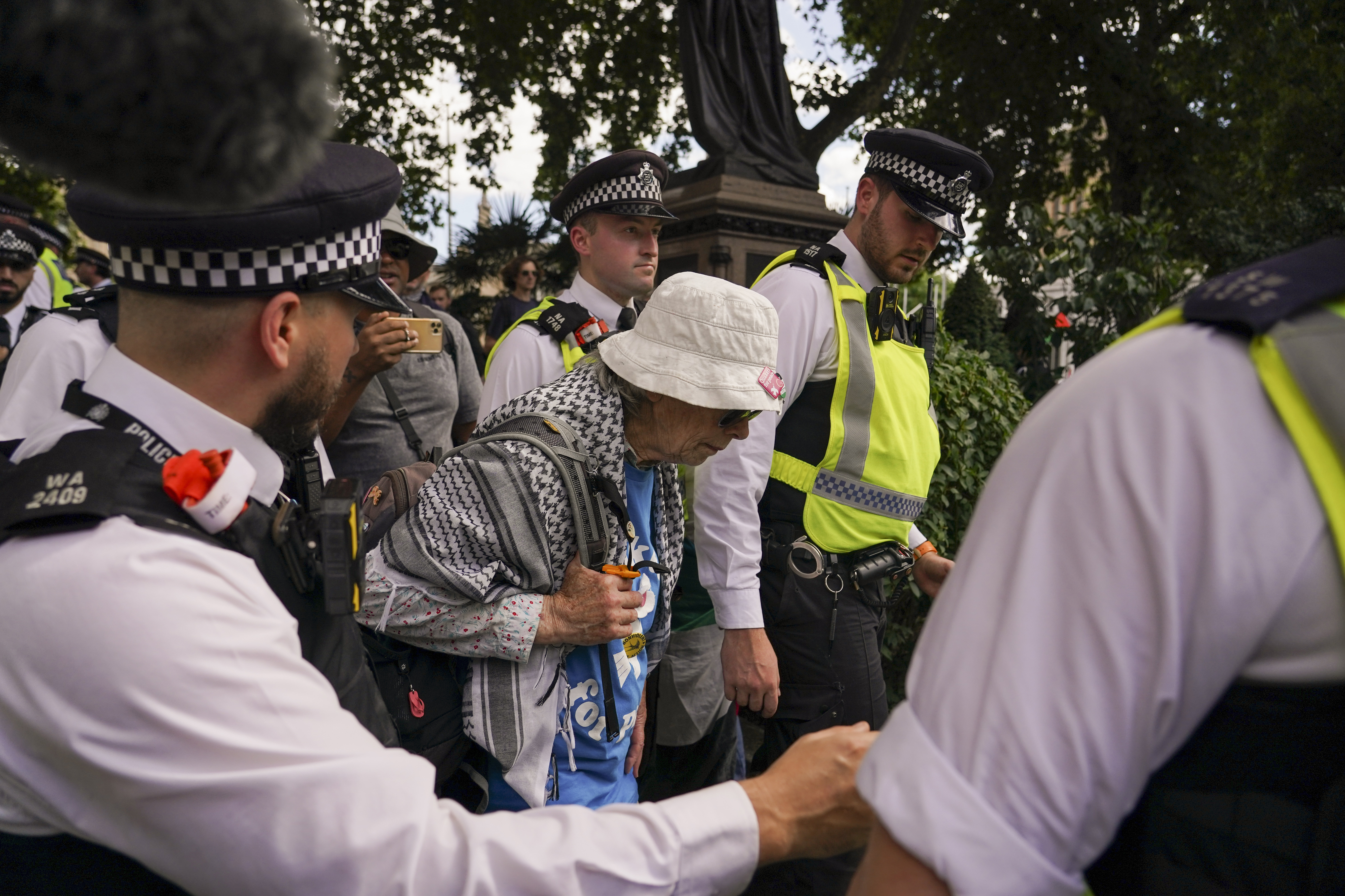 Police officers arrest a demonstrator during a protest in support of the Palestinian People in Gaza, in Parliament Square, in London