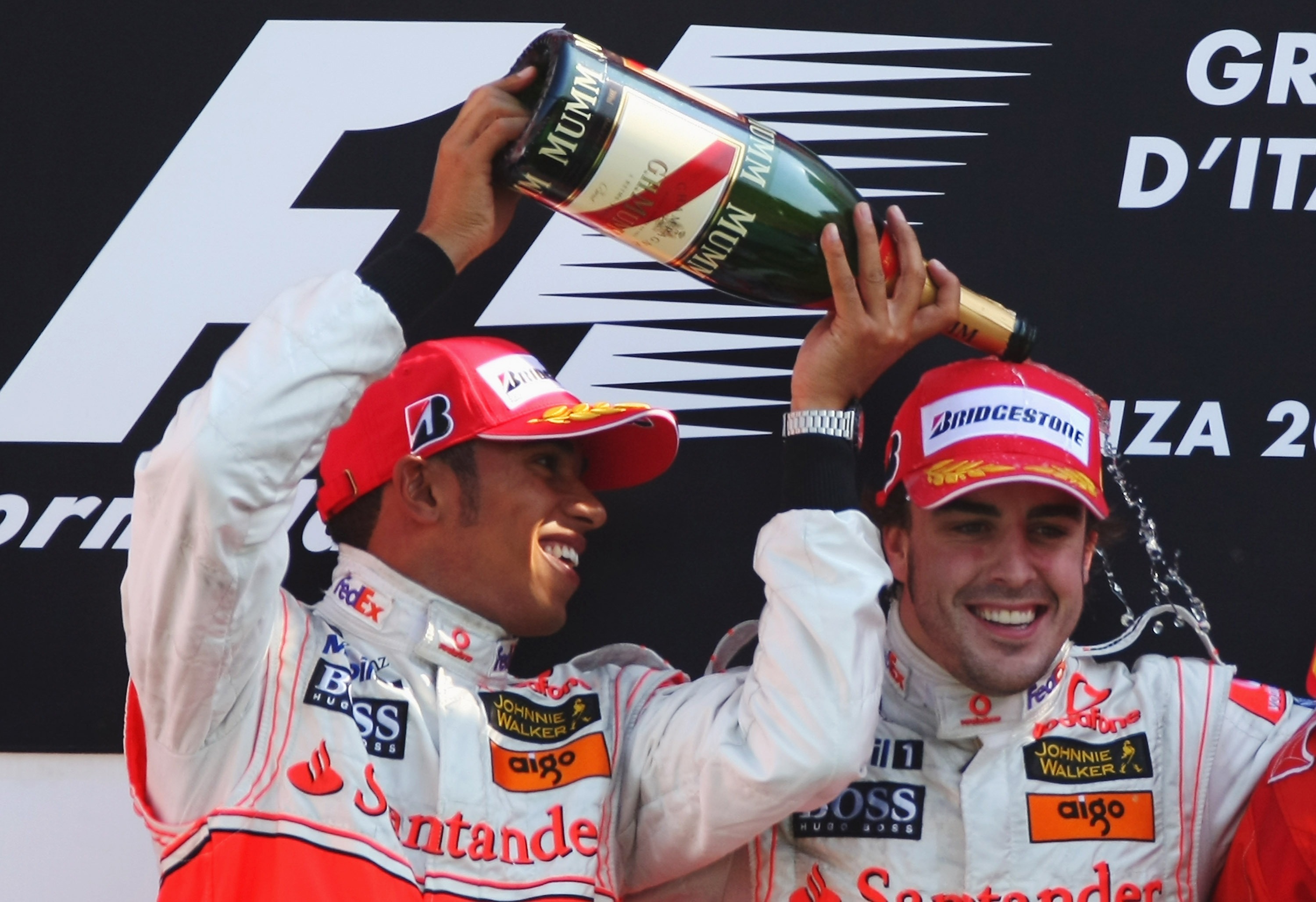 El segundo clasificado, Lewis Hamilton de Gran Bretaña y McLaren Mercedes, y Fernando Alonso de España y McLaren Mercedes celebran en el podio tras el Gran Premio de Italia de Fórmula Uno en el Autodromo Nazionale di Monza el 9 de septiembre de 2007 en Monza, Italia. (Foto de Clive Mason/Getty Images)