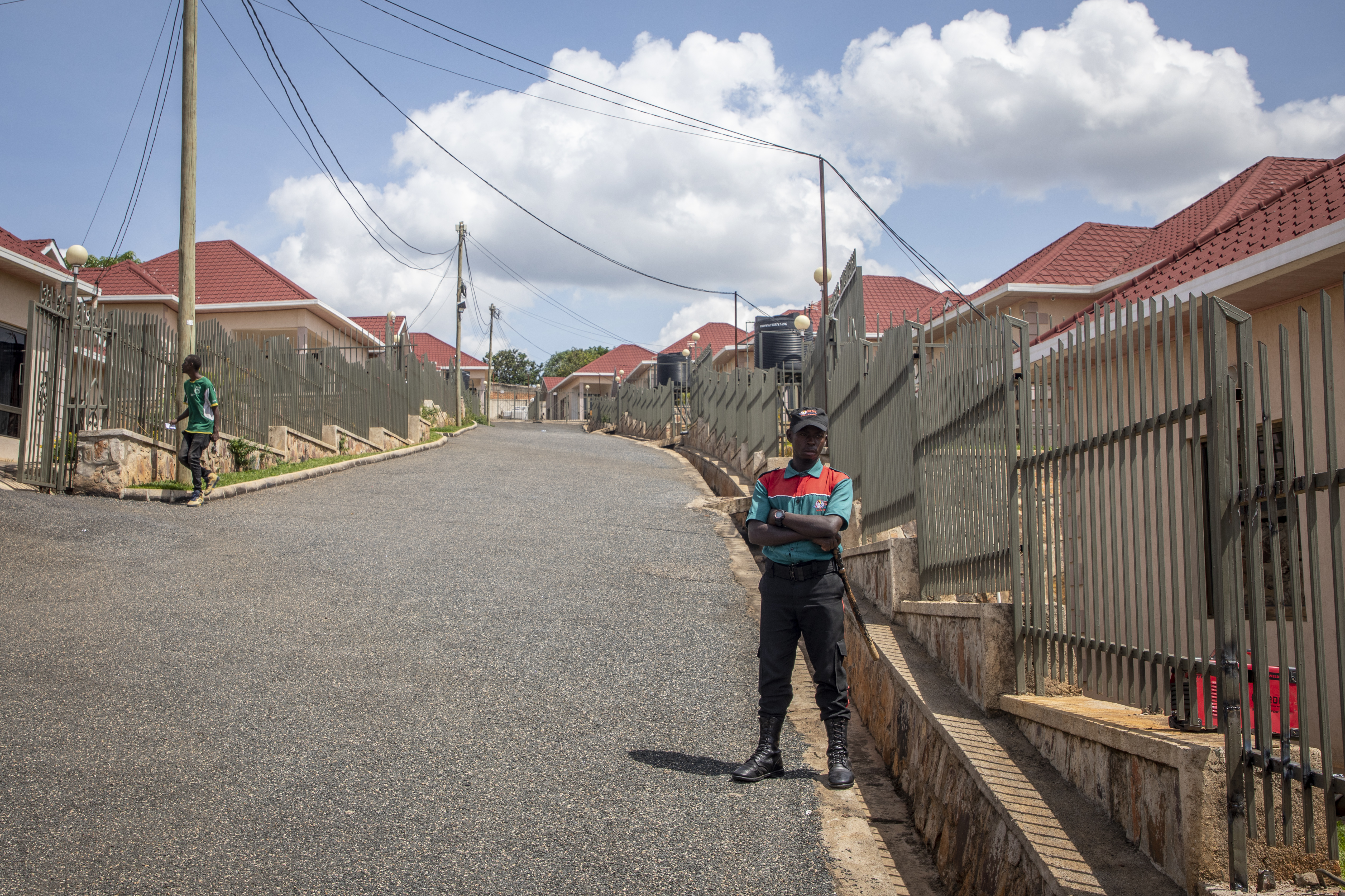 FILE - A security guard stands in the street by Hallmark Residences, which is one of the locations expected to house some of the asylum-seekers due to be sent from Britain to Rwanda, in the capital Kigali, Rwanda on May 19, 2022. A group of asylum-seekers asked a U.K. court on Friday, June 10, 2022 to stop the British government sending them on a one-way flight to Rwanda. (AP Photo/File)