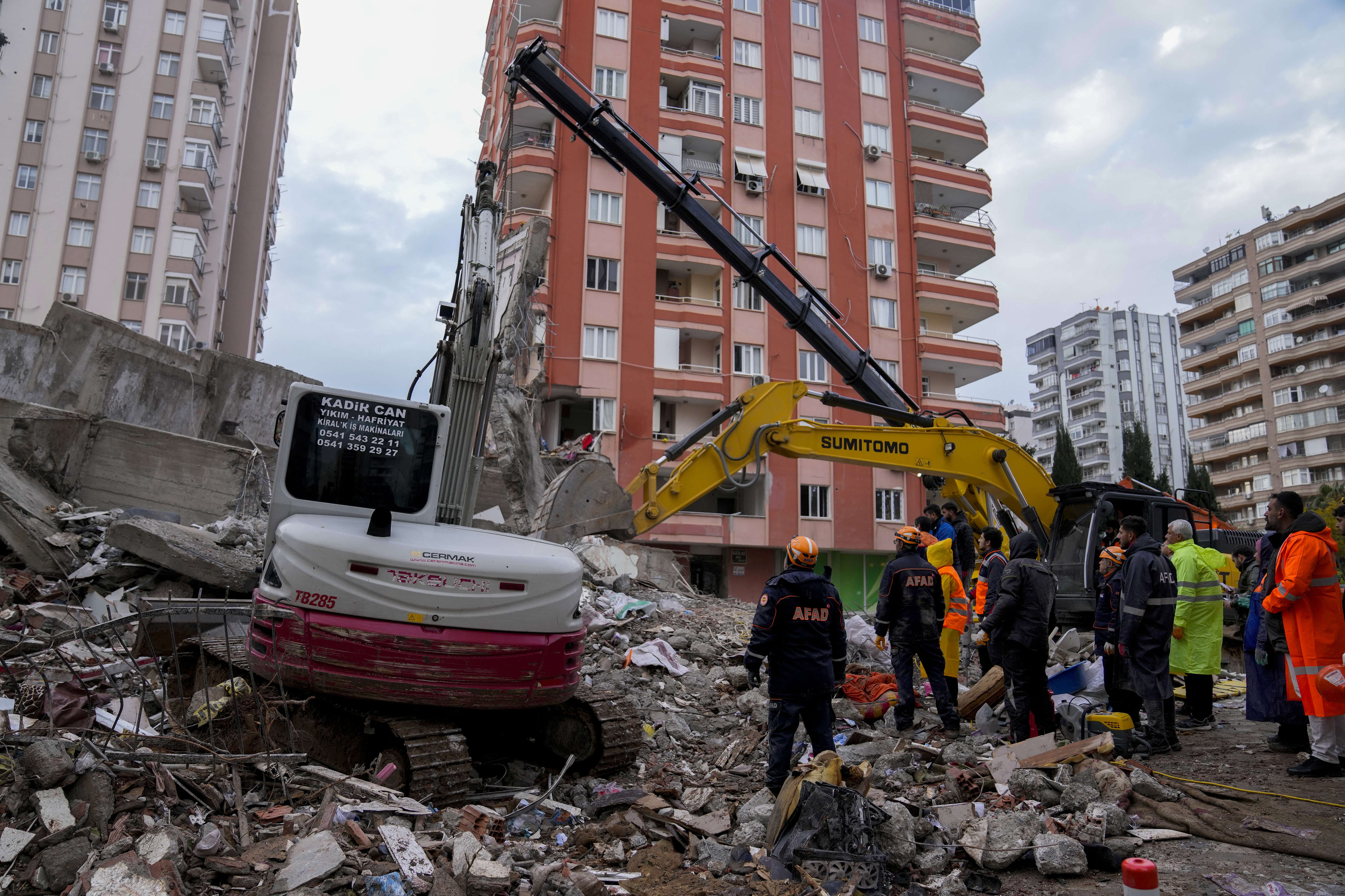 Emergency teams search for people in the rubble of a destroyed building in Adana, Turkey, Monday, Feb. 6, 2023. 