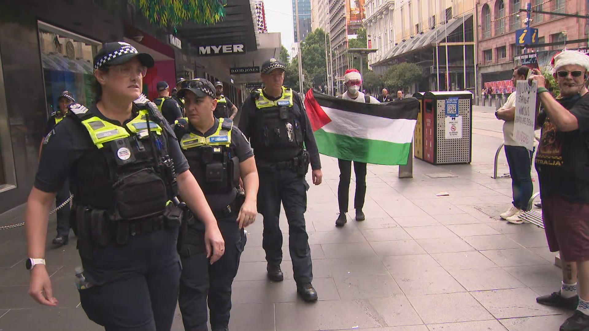 Protesters heckle shoppers outside Myer’s Christmas windows but main rally stays away