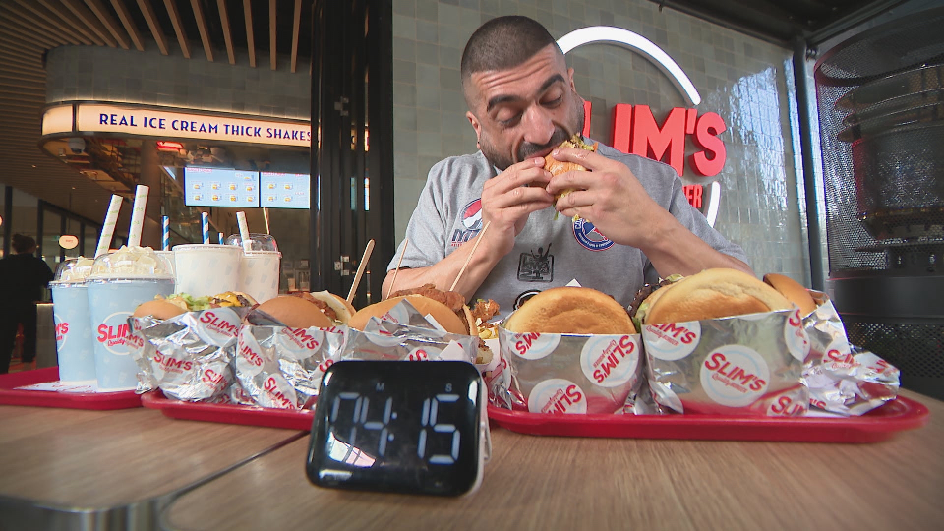 Professional eater James Webb trains for Hot dog competition in Coney Island by eating burgers.