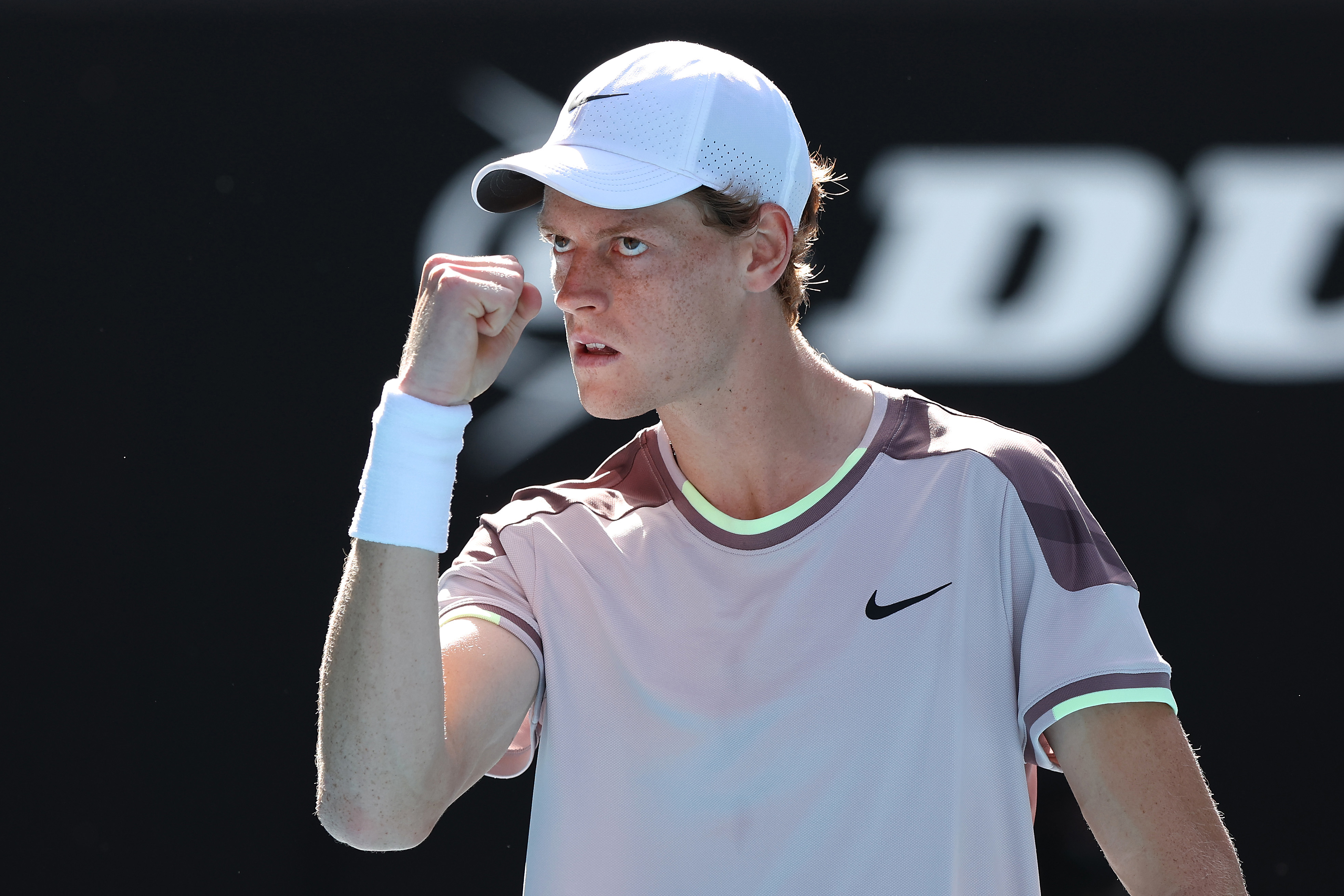 Jannik Sinner celebrates winning a point in their semi-final singles match against Novak Djokovic at the 2024 Australian Open.