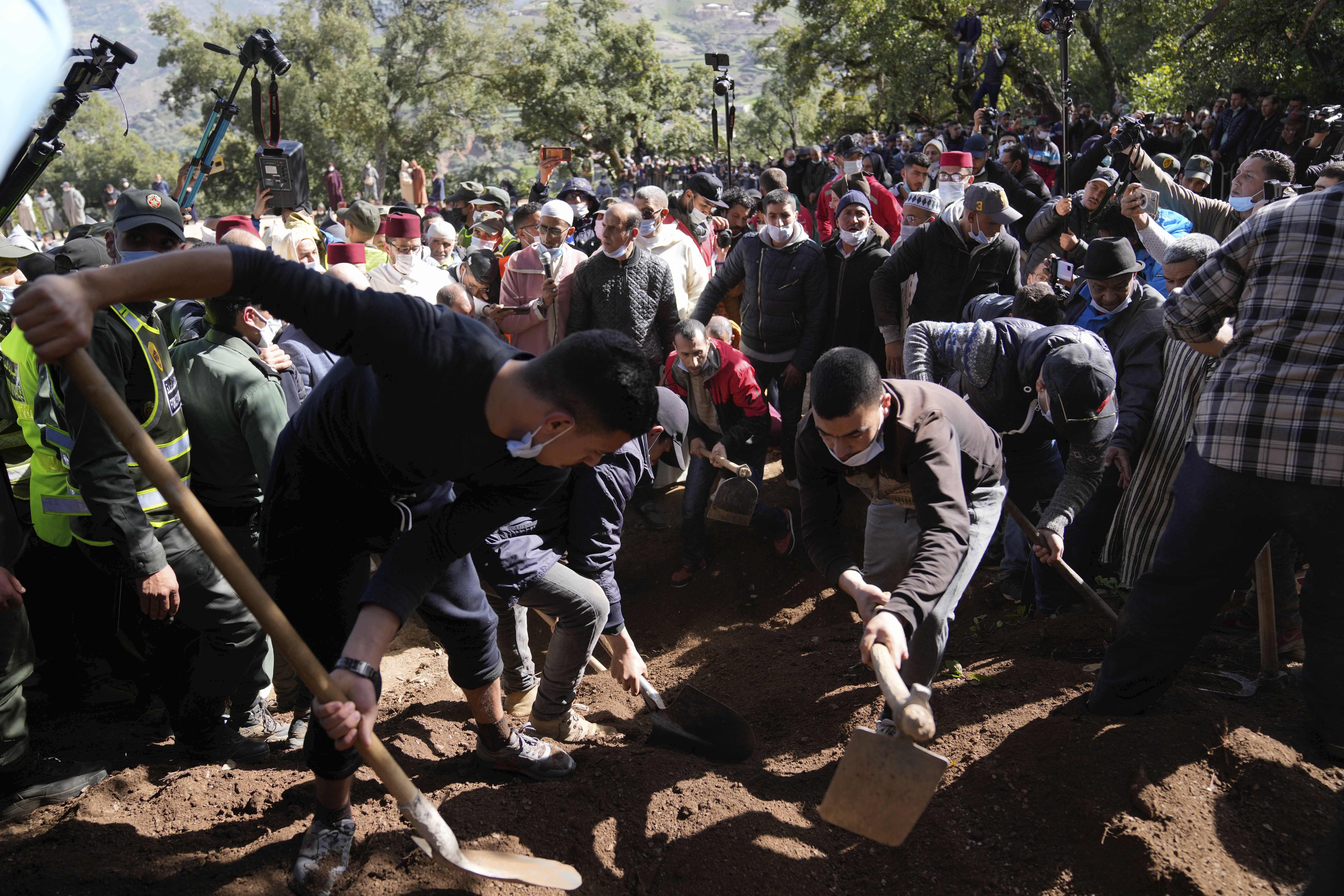 Residents watch in concern as civil defense and local authorities dig in a hill as they attempt to rescue a 5 year old boy who fell into a hole near the town of Bab Berred near Chefchaouen, Morocco, Thursday, Feb. 3, 2022. (AP Photo)