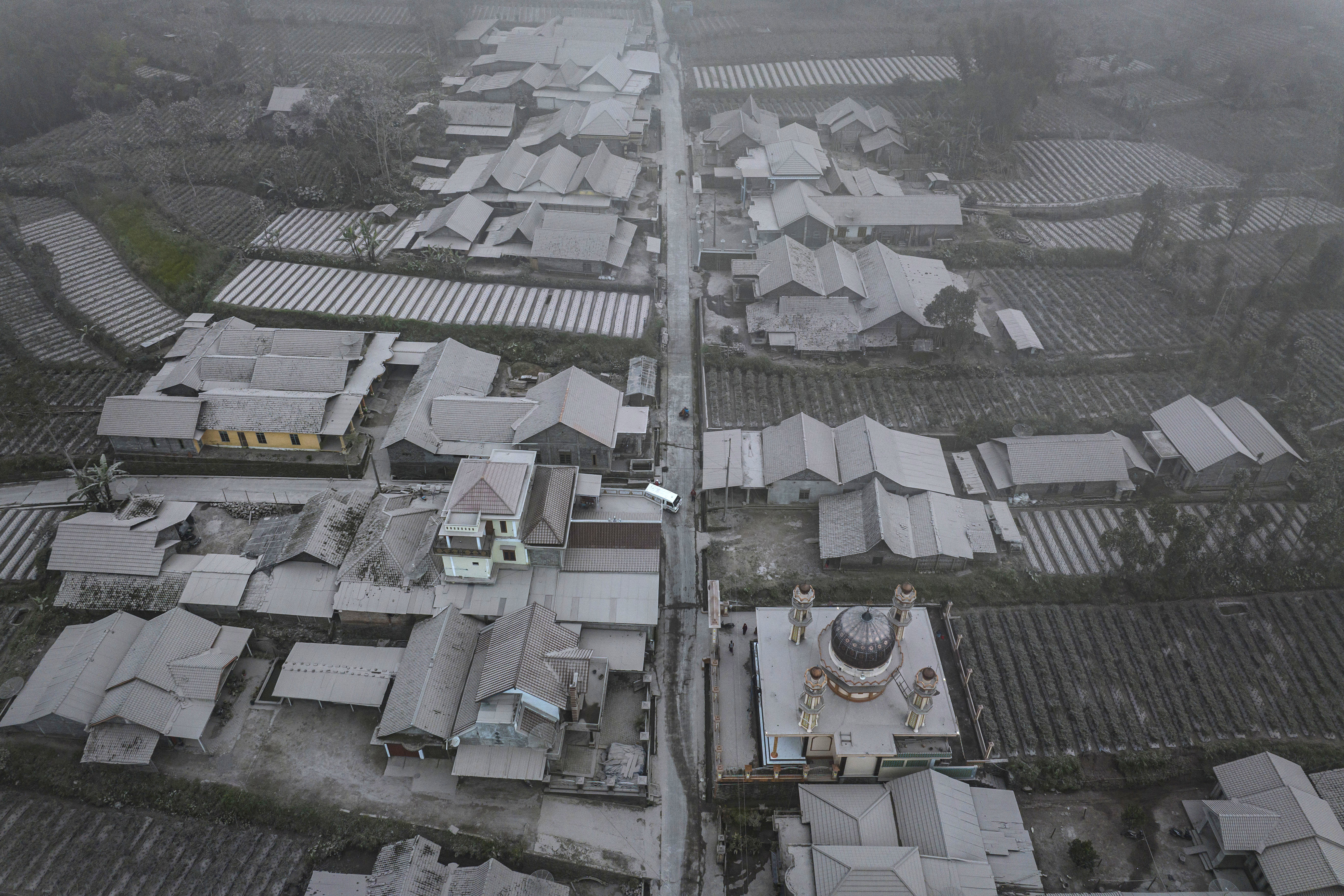 An aerial view of houses covered by ash after Mount Merapi erupted spewing volcanic materials at Stabelan village on March 11, 2023 in Boyolali, Central Java, Indonesia. Mount Merapi, 2,968 metres high, is known as one of the most active volcanoes in Indonesia, with an eruption occurring every two to five years.