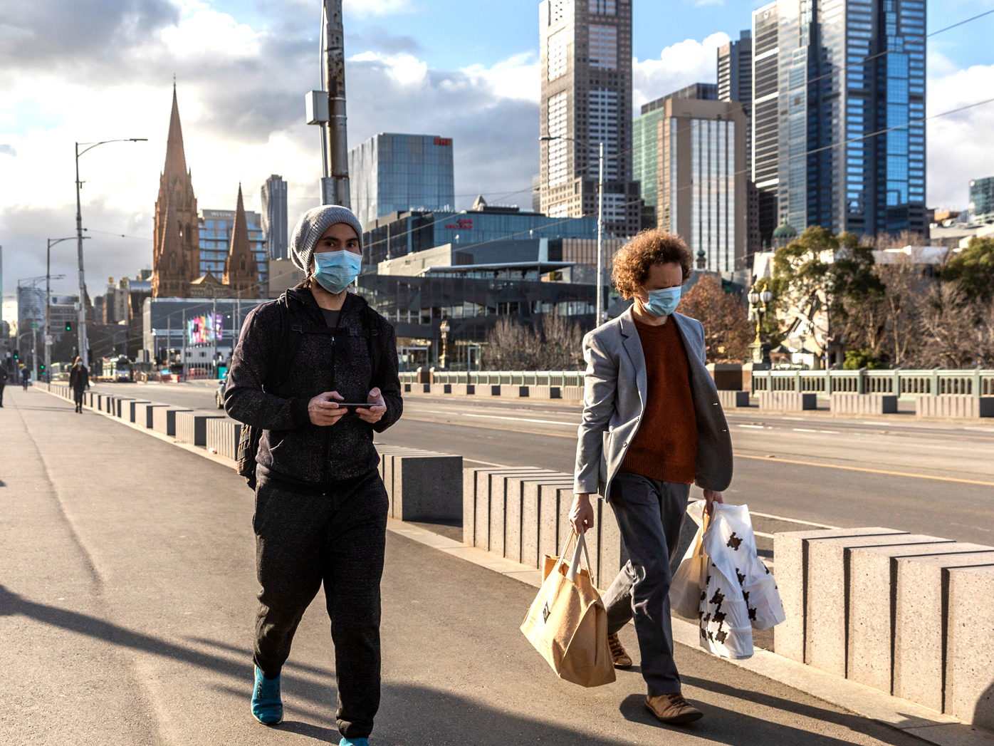 Pedestrians walk away from the central business district in Melbourne.