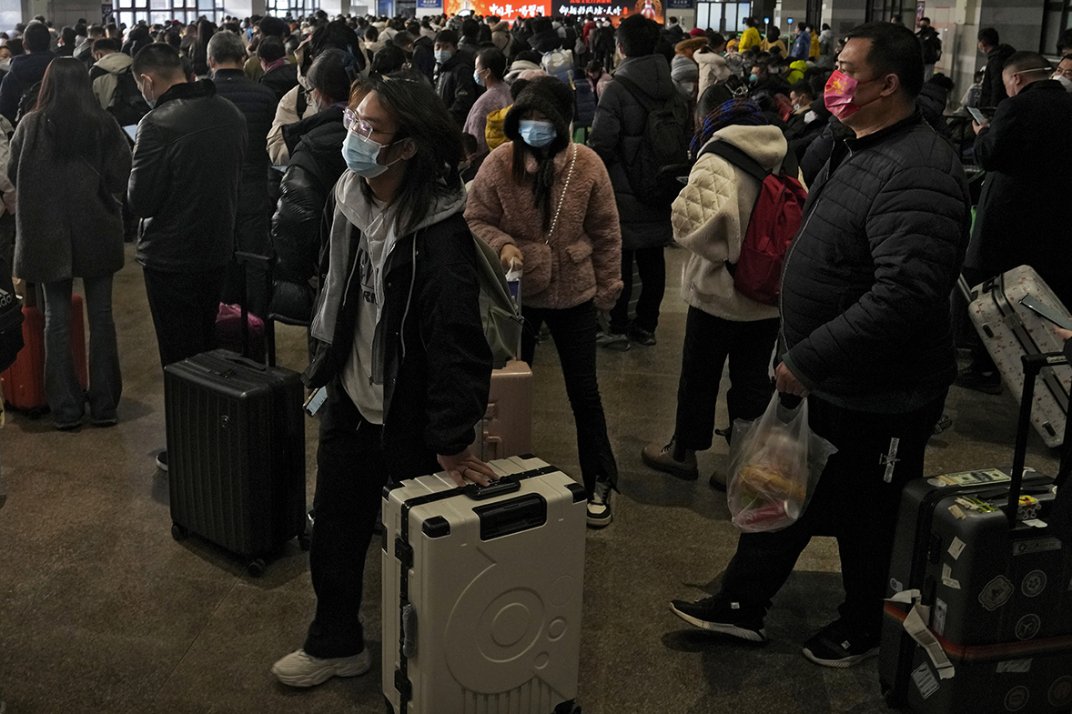 Travelers arrive at a departure hall to catch their trains at the West Railway Station in Beijing