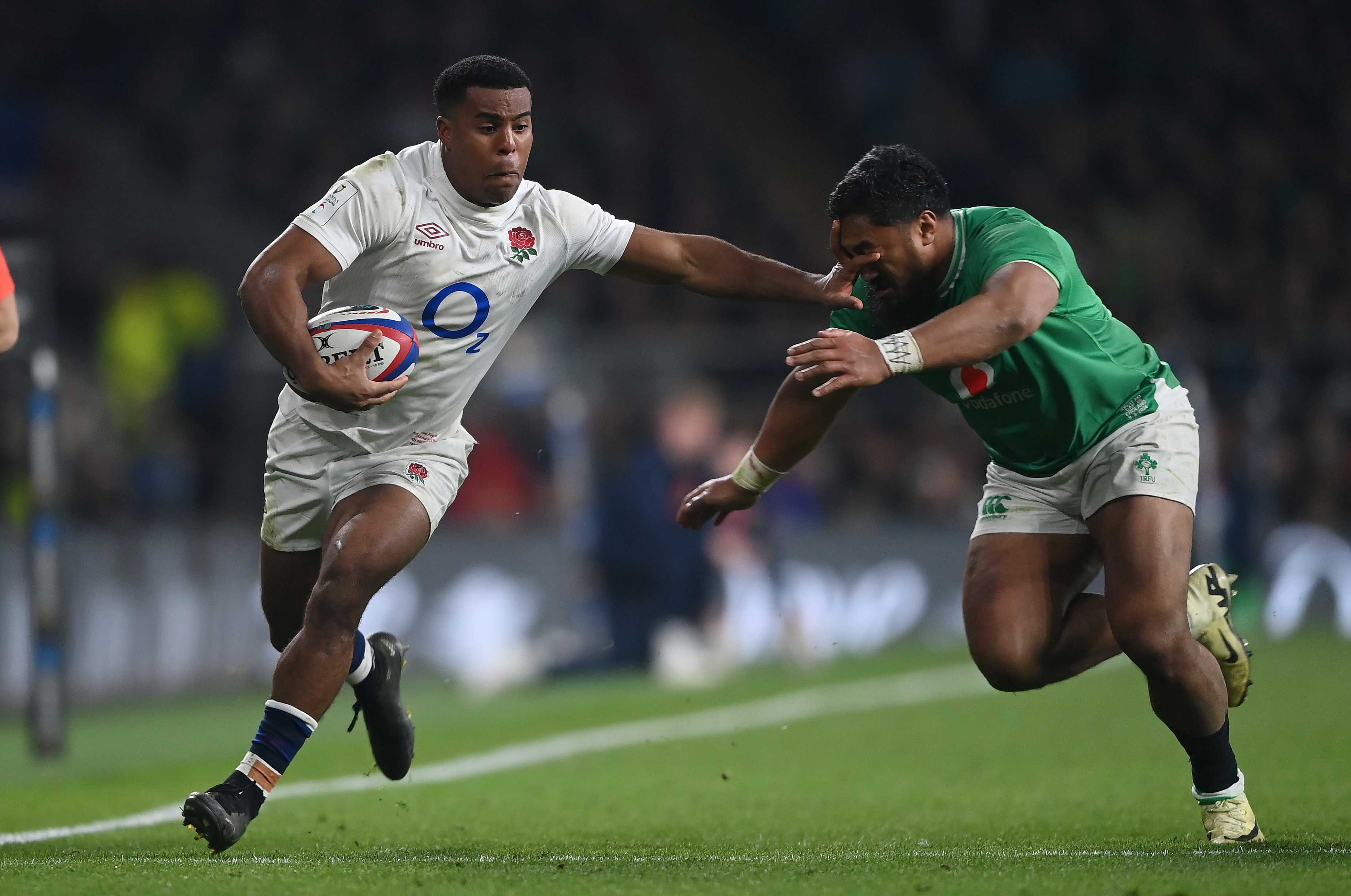 Immanuel Feyi-Waboso of England hands off Bundee Aki of Ireland.