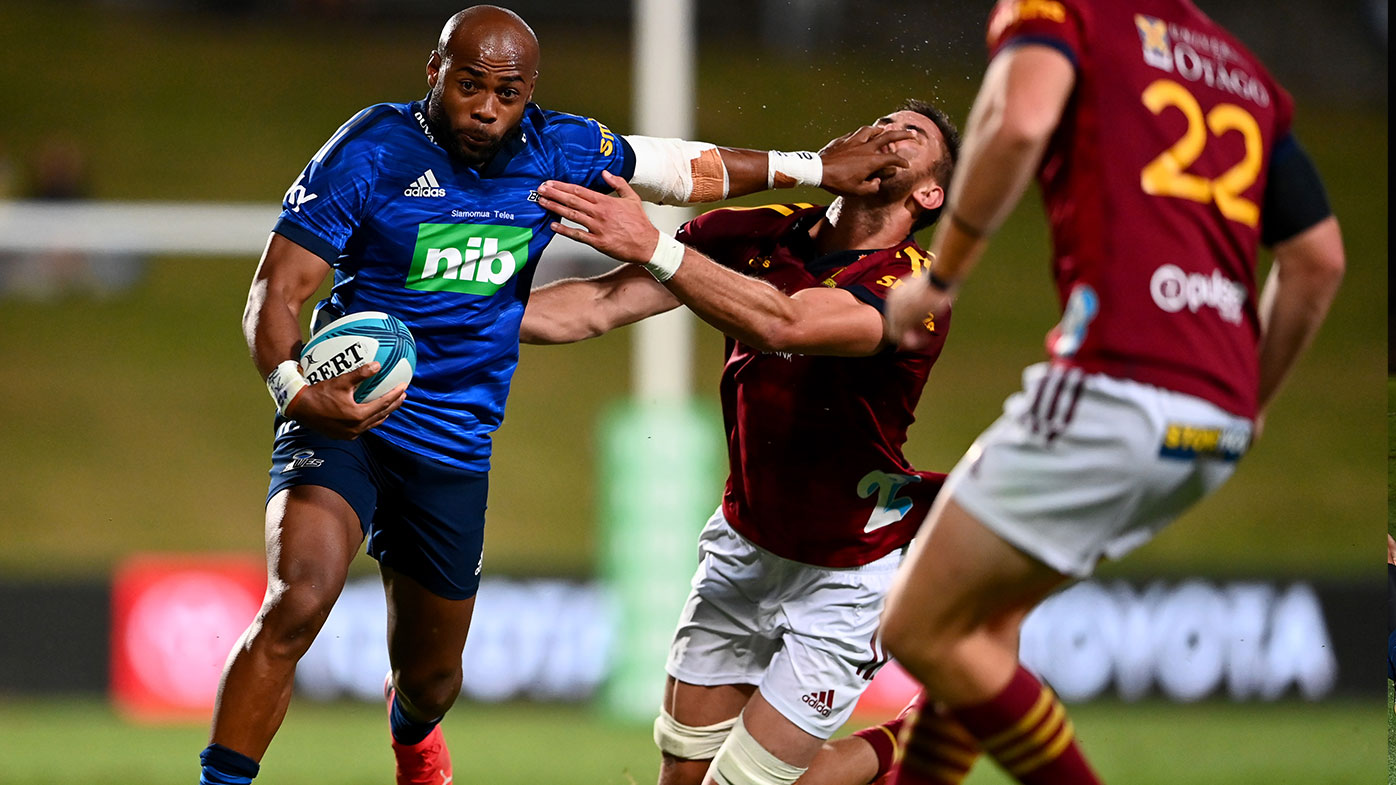 Mark Telea of the Blues fends off Manaaki Selby-Rickit of the Highlanders